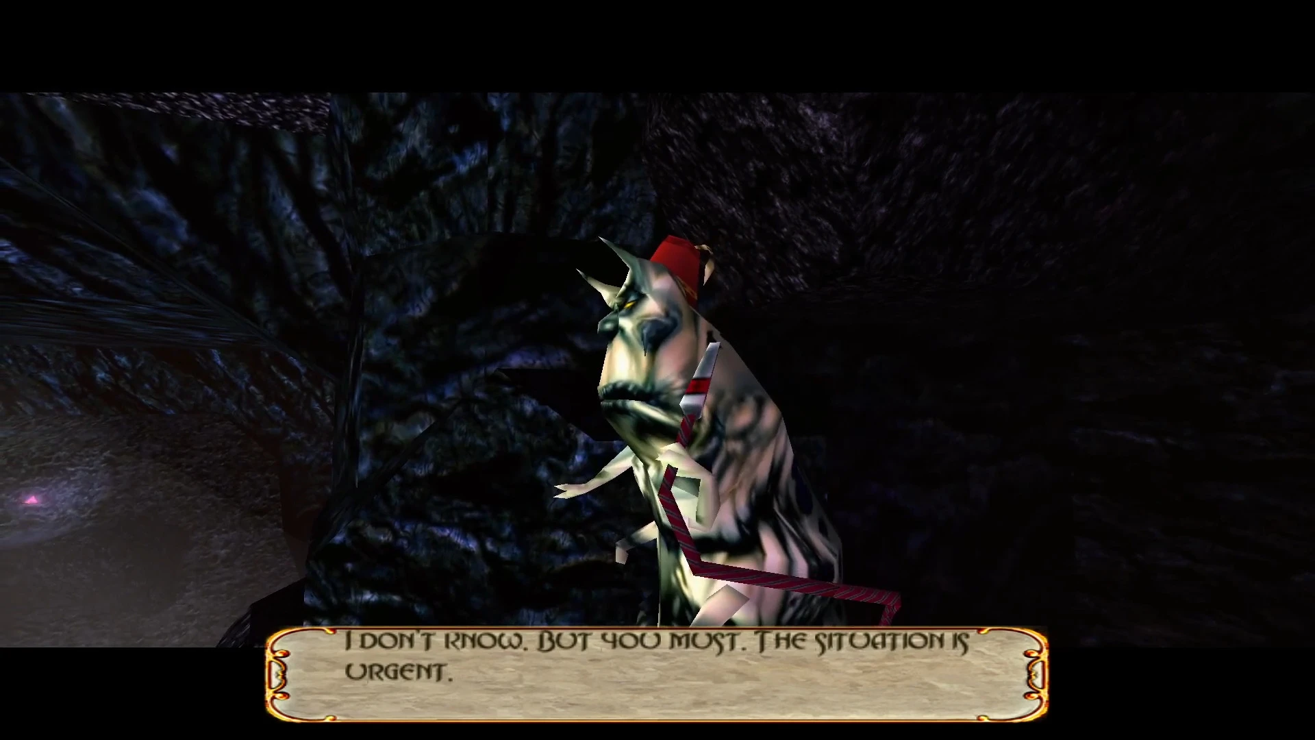 A unicorn-like creature with a red fez hat stands in a dark rocky cave with English subtitles