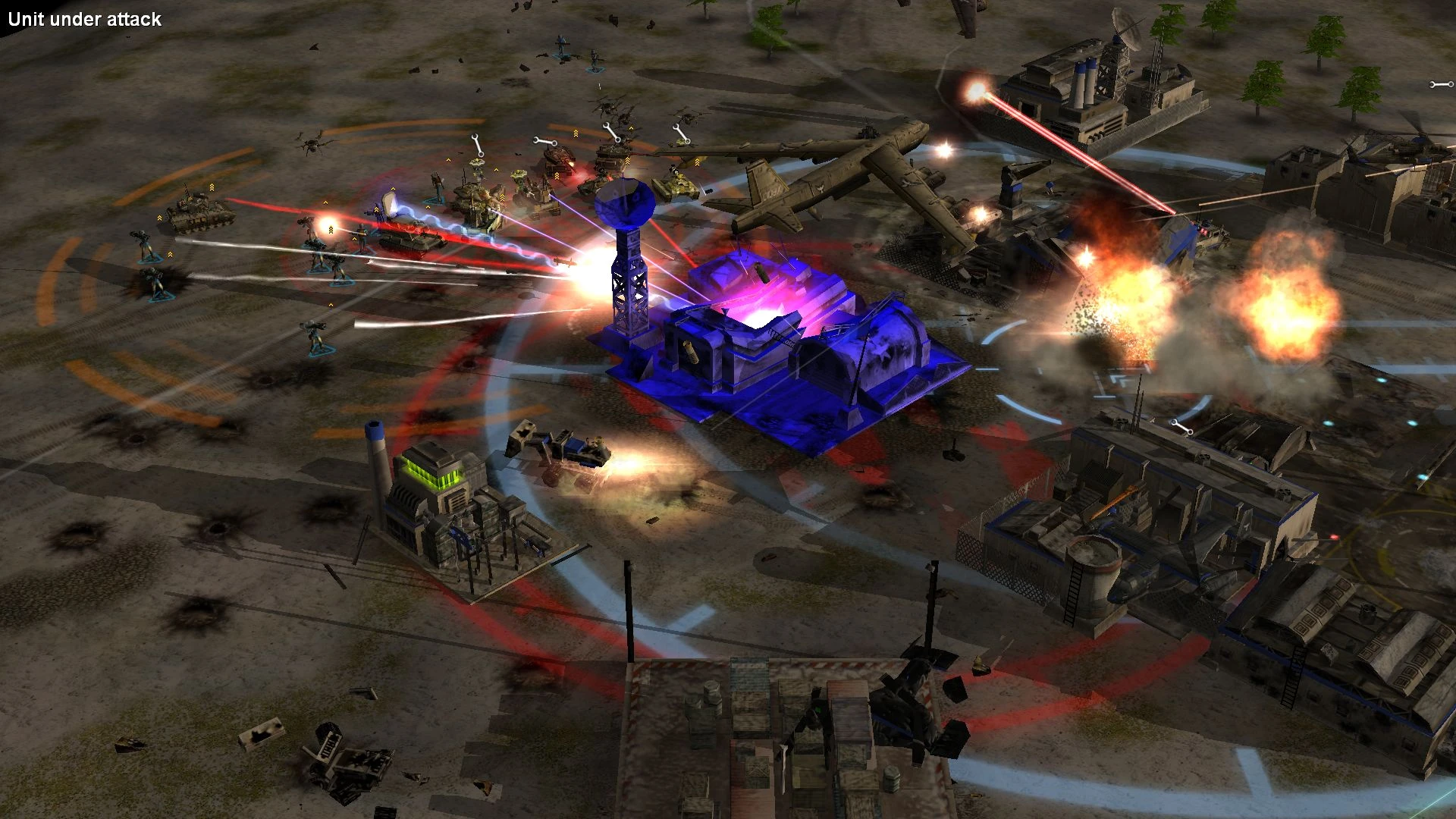 Screenshot shows a base under heavy attack with explosions and laser fire in Command & Conquer Generals mod