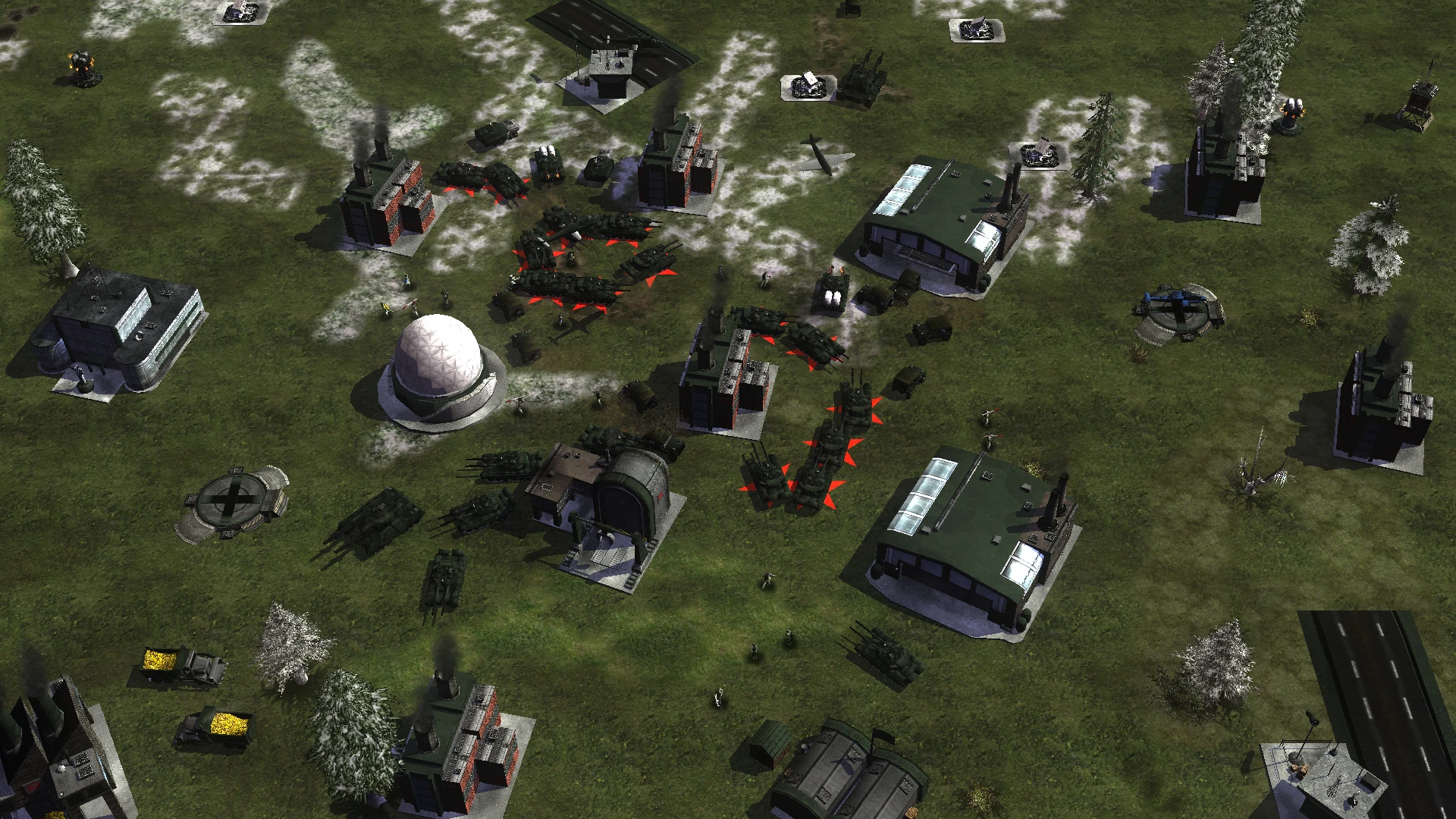 Overhead view of tanks and military buildings on a grassy snowy battlefield in the C&C Tiberian Dawn Redux mod