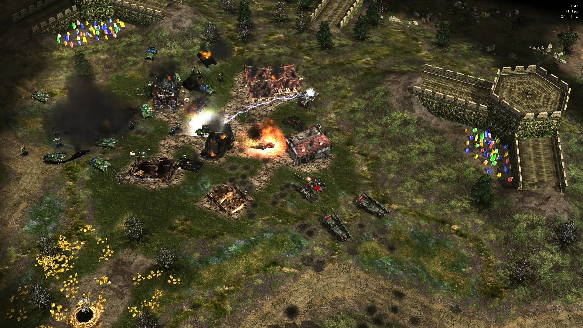 Explosions and burning buildings during vehicle combat near a fortified wall with colorful crystals