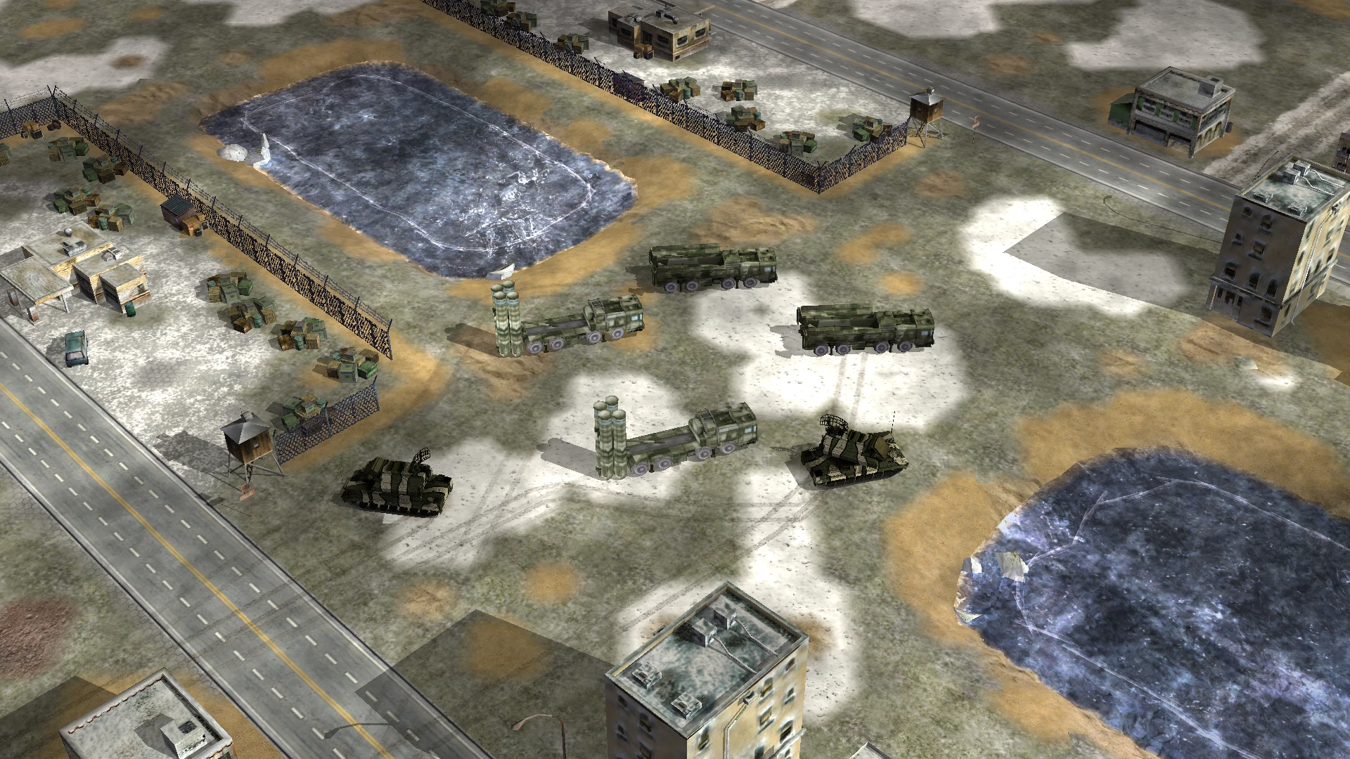 Luftansicht von Raketenfahrzeugen und Radaranlagen in einem schneebedeckten, eingezäunten Militärgebiet aus dem Command & Conquer: Generals Crash of War Mod