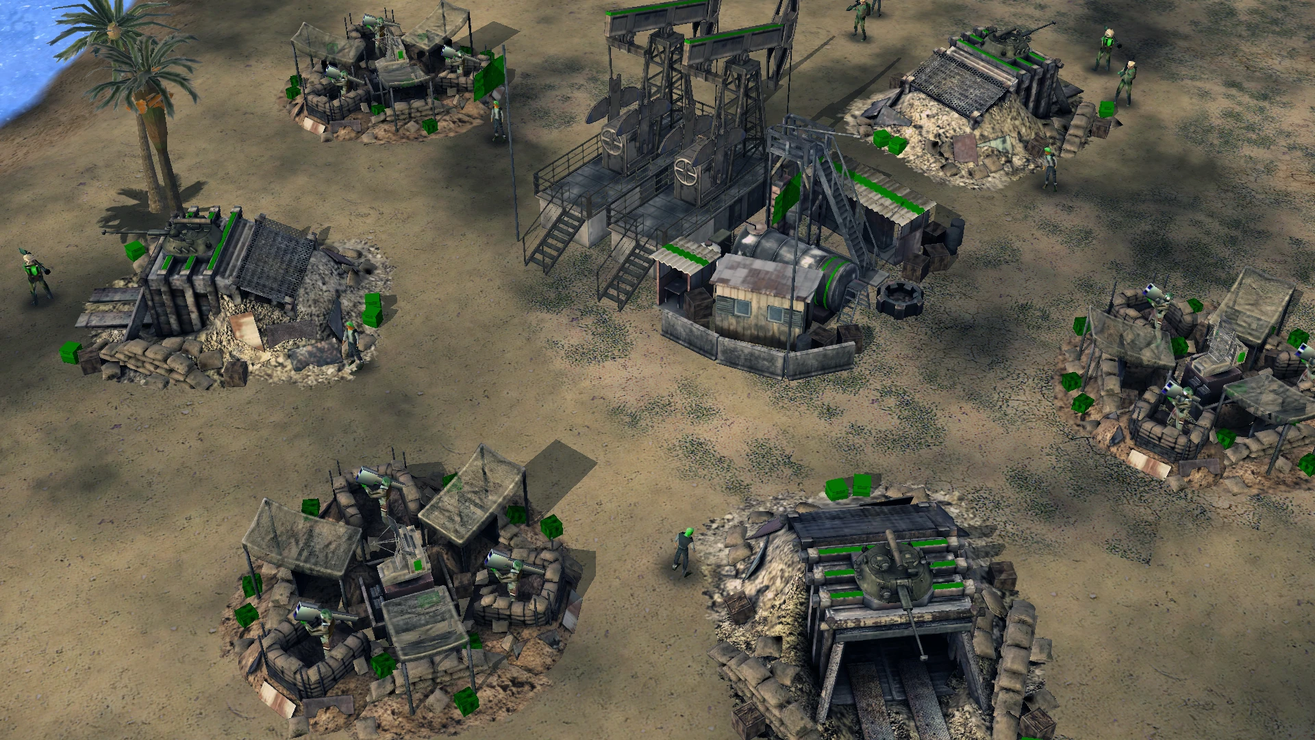 Draufsicht auf militärische Verteidigungsanlagen mit Sandsackbunkern, Soldaten und Ölpumpen in einer Wüstenbasis des Mods