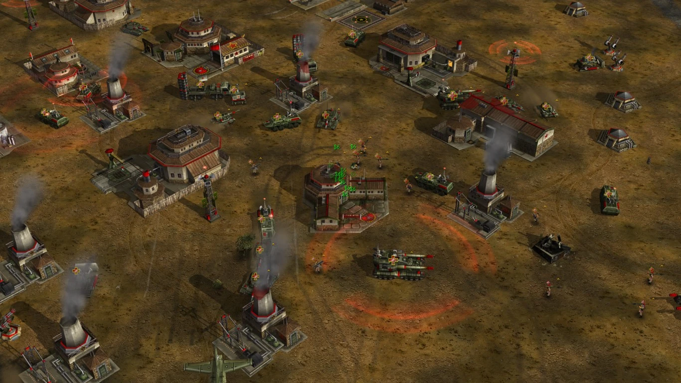 Widok z góry na bazę wojskową z budynkami, czołgami i jednostkami piechoty walczącymi w modzie Command & Conquer Generals
