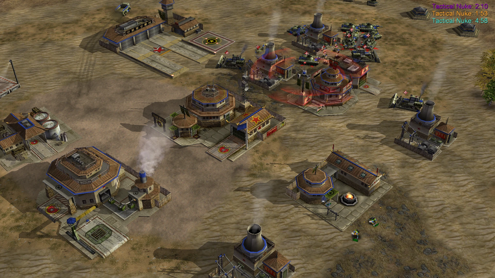 Aerial view of a military base with various buildings and defense structures in a desert map