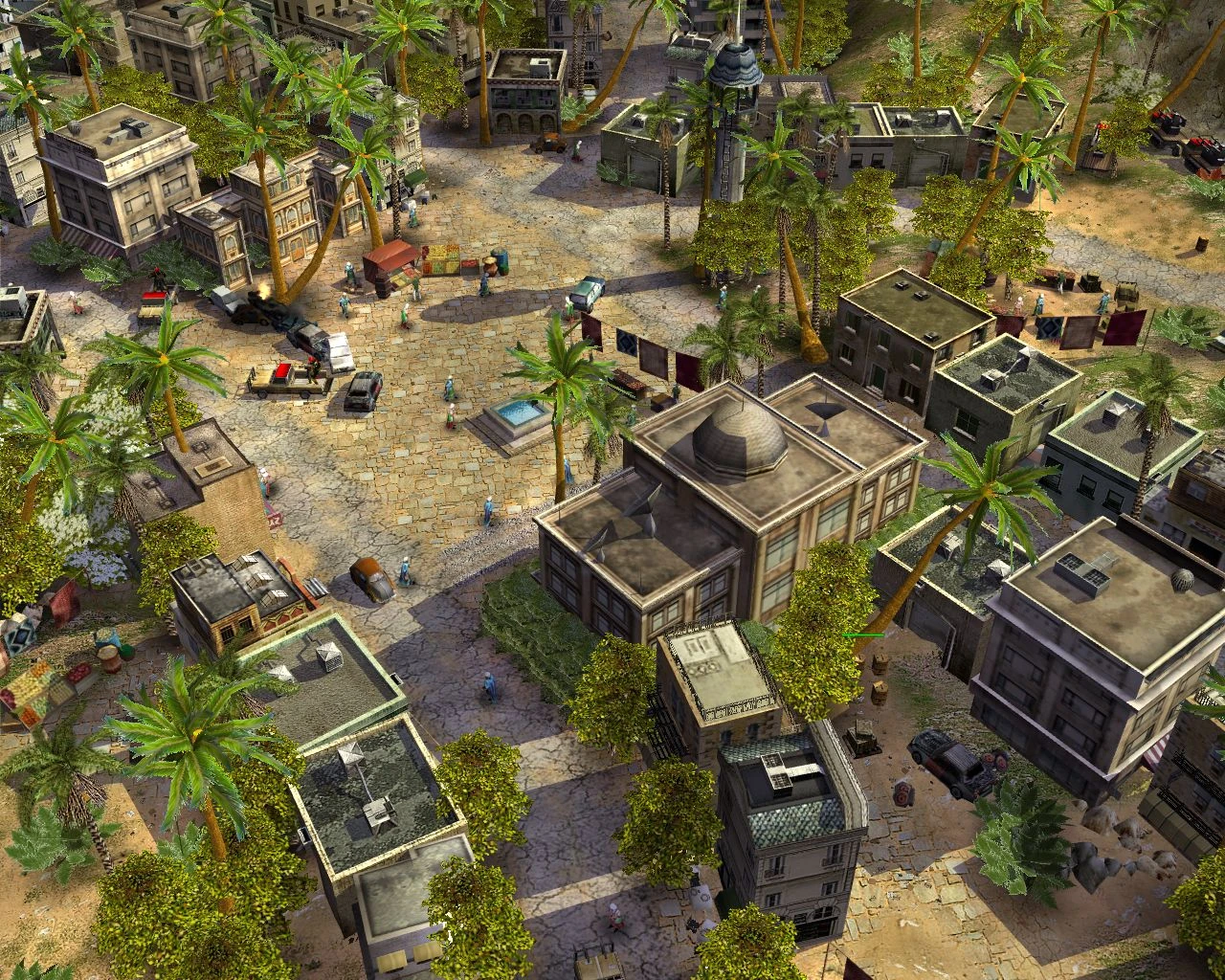 Aerial view of a desert city in Command & Conquer Generals mod The Foxtrot Code with buildings, palm trees, and scattered units
