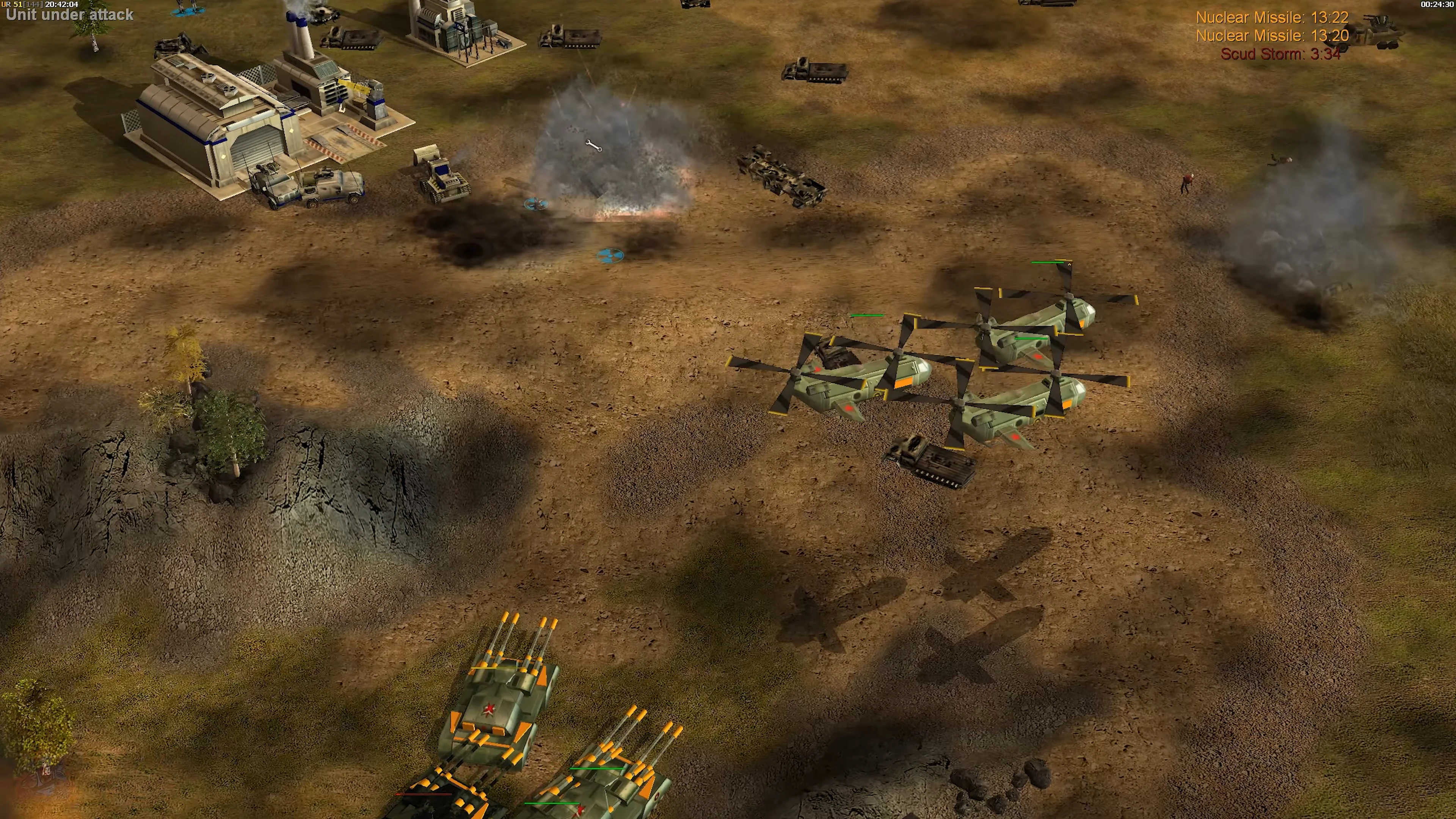 A group of helicopters and artillery units engage in battle next to a base under attack in Command & Conquer Generals The Power Of The West mod