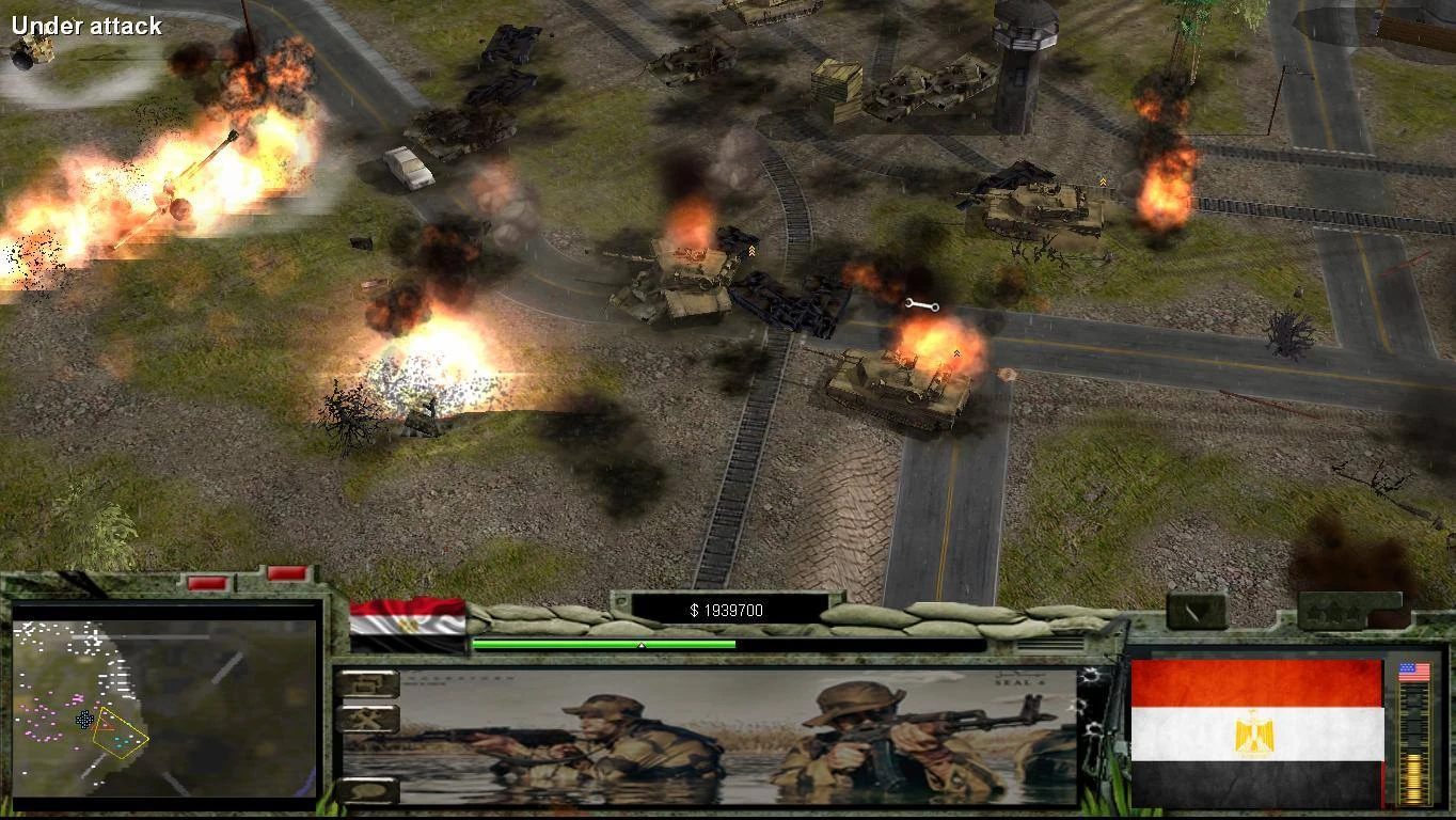 Скриншот геймплея с горящими танками и взрывами на поле боя из мода Victory or Death для Command & Conquer: Generals