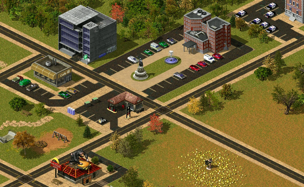 Vista superior de una ciudad en el mod Scorched Earth de Red Alert 2 con edificios, carreteras, autos y áreas verdes