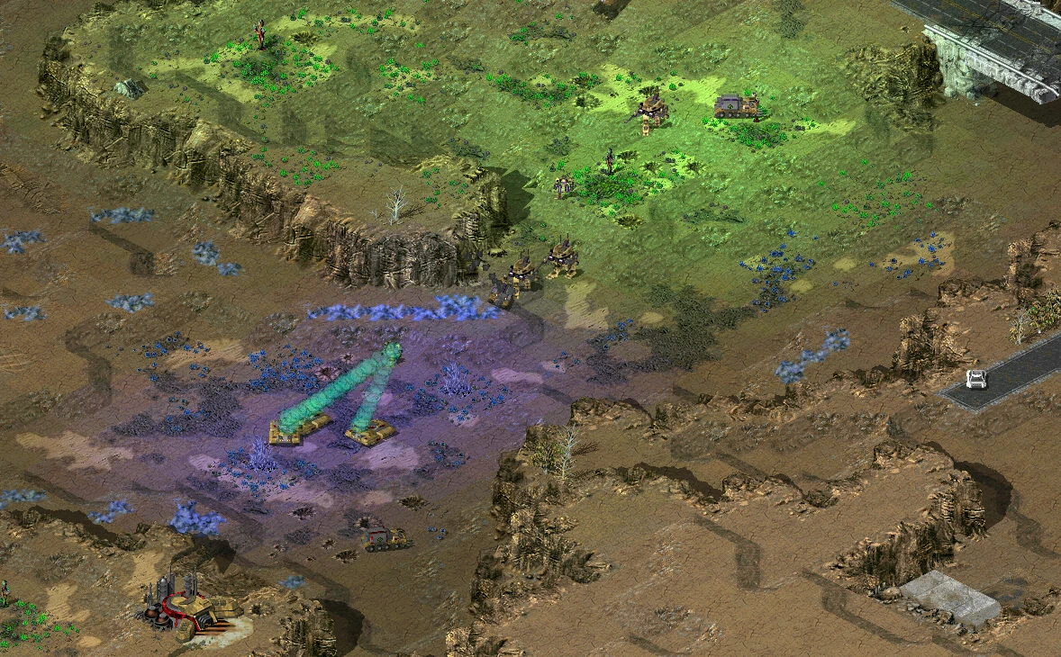 In-game screenshot showing tanks firing in a rocky terrain area in Command & Conquer Tiberian Sun mod