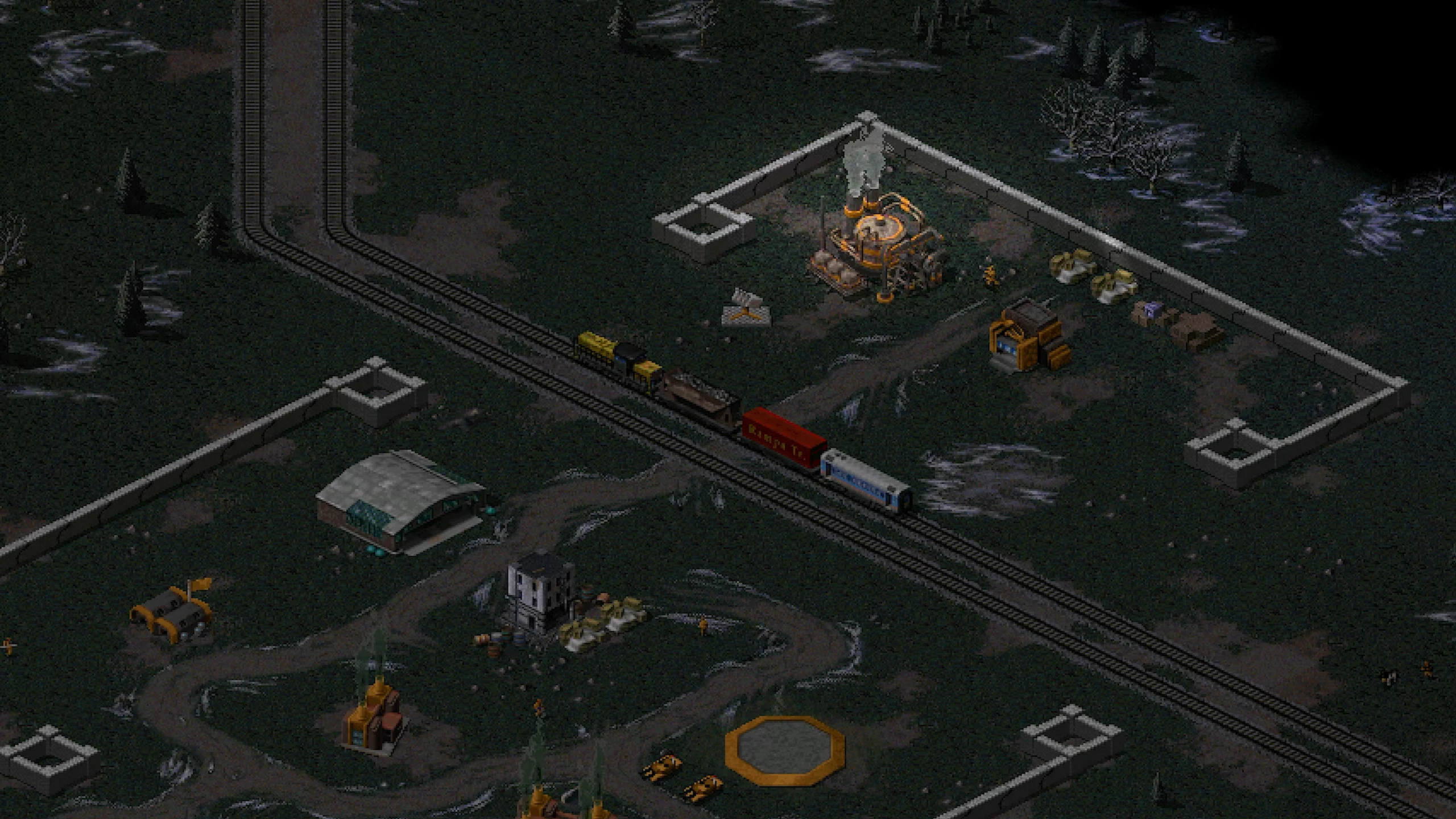 Luftaufnahme einer nächtlichen strategischen Basis mit Eisenbahnstrecke und Industriebauten im Dawn of the Tiberium Age Mod