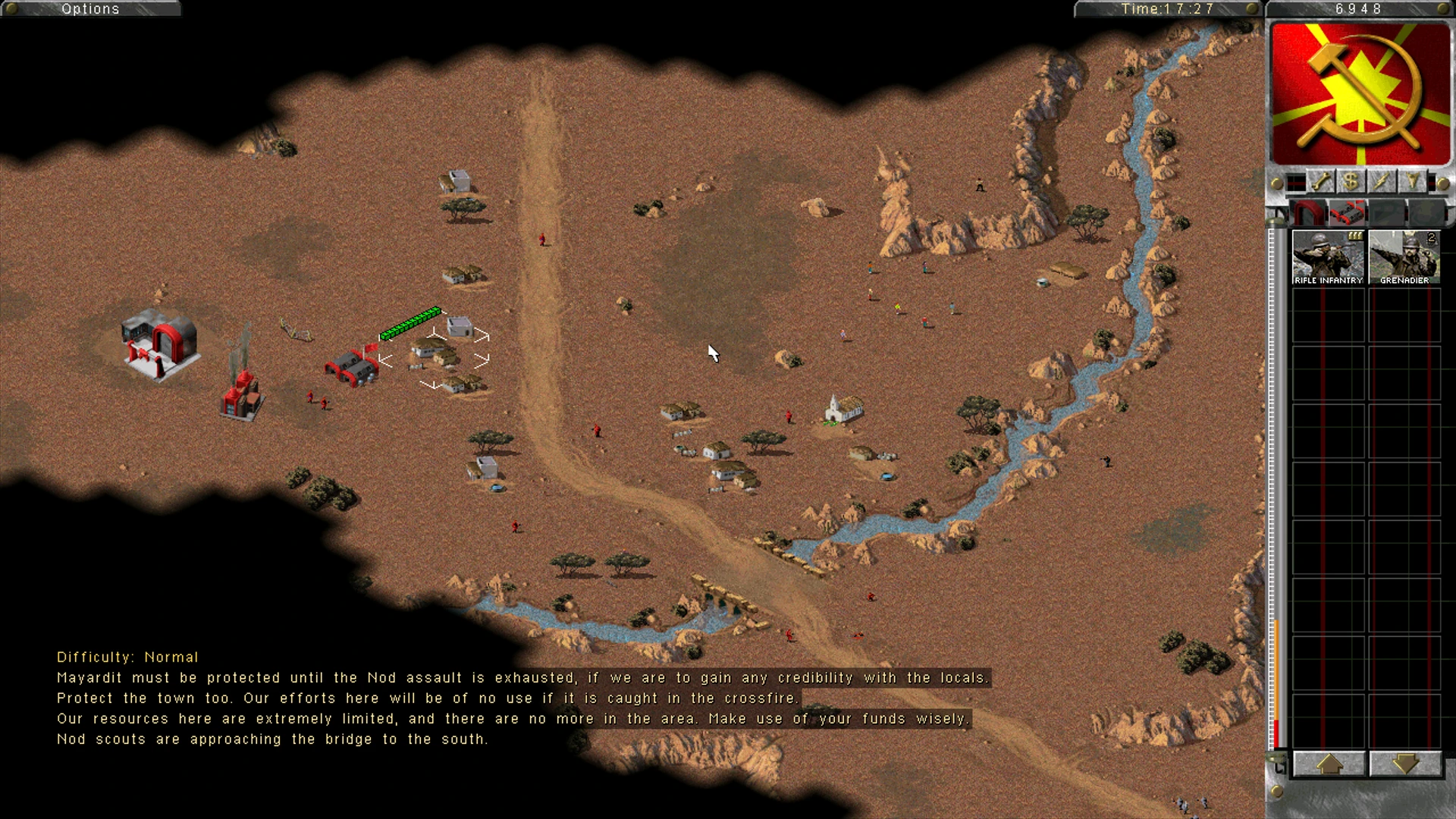 Command & Conquer Dawn of the Tiberium Age Mod zeigt Nod-Einheiten, die eine Wüstenstadt nahe einem Fluss und Felsen verteidigen