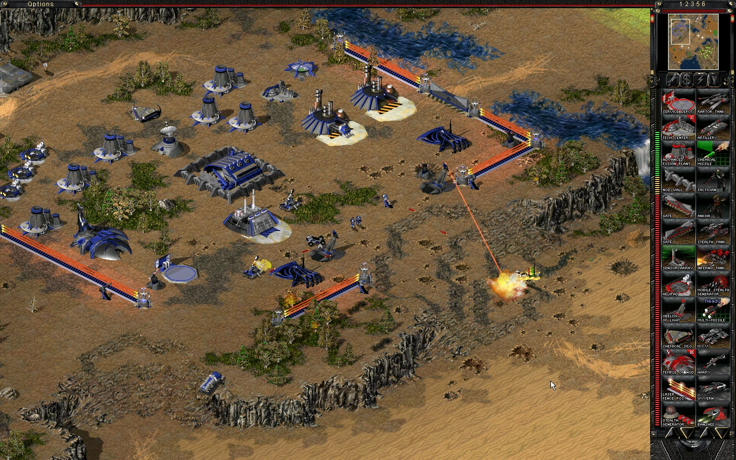 Screenshot einer befestigten Basis mit blauen Gebäuden und laserzäunen im The Second Tiberium War Mod für Command & Conquer: Tiberian Sun