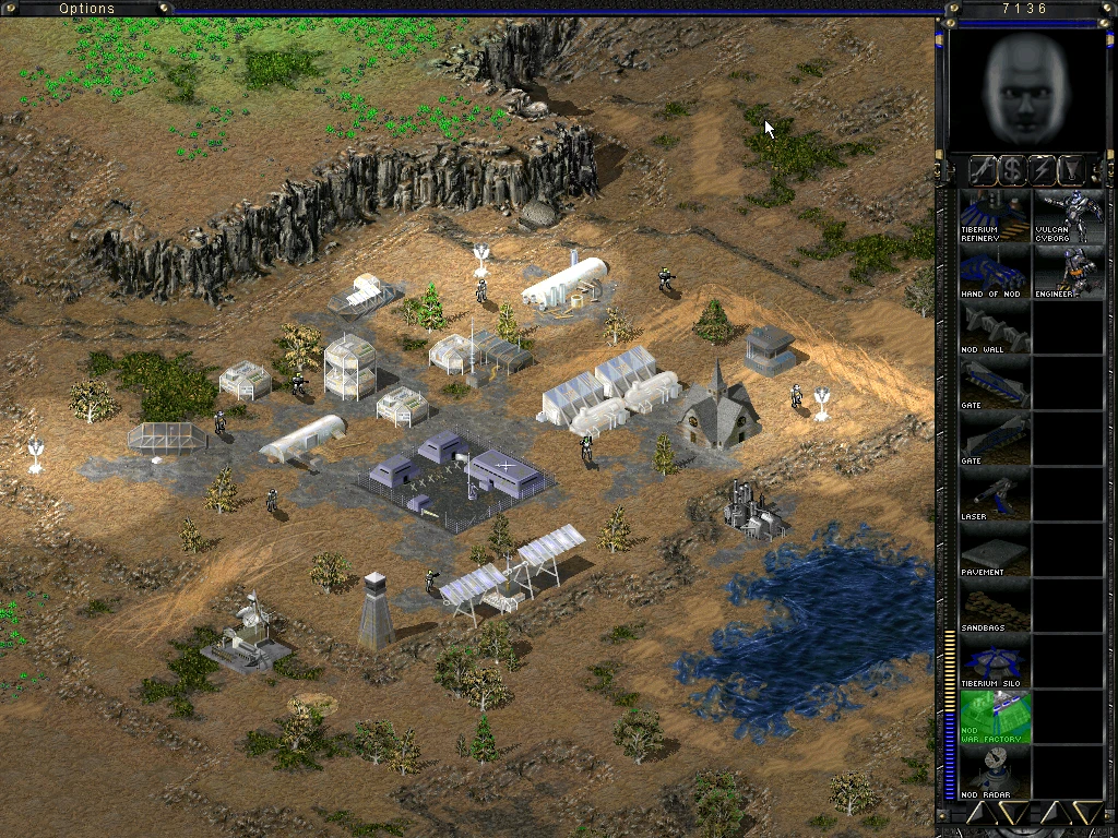 Ingame-Screenshot von Command & Conquer Tiberian Sun mit Nod-Basis, Gebäuden, Einheiten und Bedienfeld