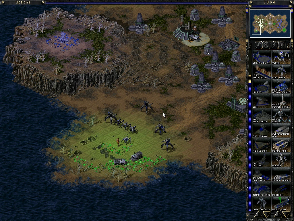 Draufsicht auf einen Command & Conquer Tiberian Sun Spielbildschirm mit Basisstrukturen, Verteidigungseinheiten und Küstenlandschaft