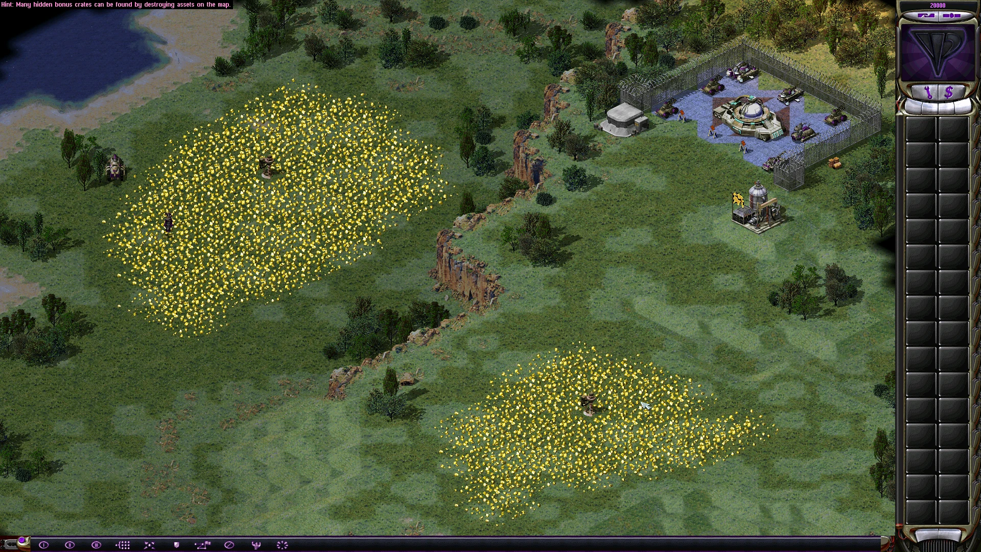 Вид из игры Command & Conquer Yuri's Revenge мод C&C Reloaded с вражеской базой, двумя желтыми полями бонусных ящиков и юнитами