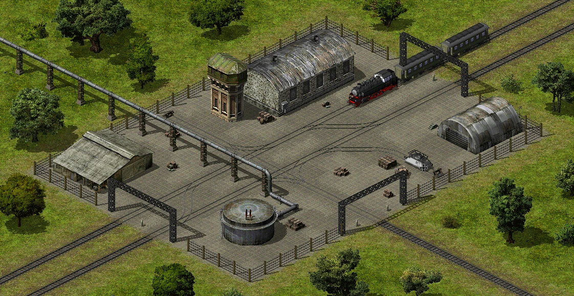 Eingezäunter Rangierbahnhof mit Dampflokomotive, Panzer und Industriegebäuden in grüner Landschaft