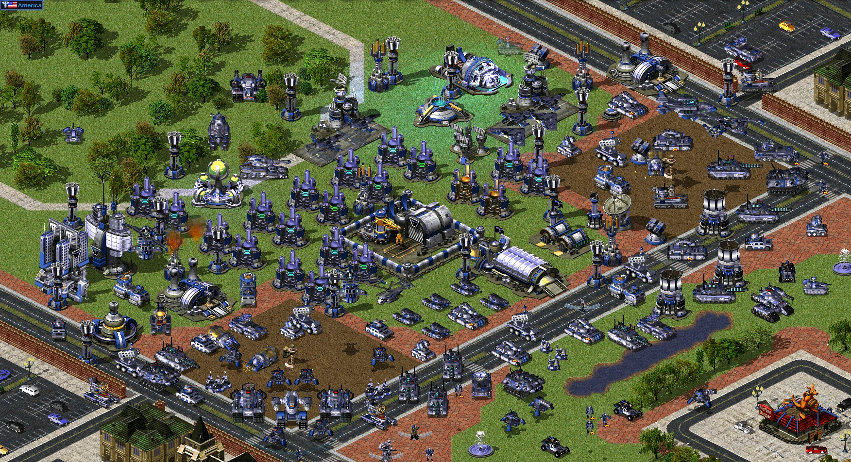 Widok z góry na dużą bazę wojskową z czołgami, wieżyczkami i budynkami w modzie Reboot do Command & Conquer Yuri's Revenge