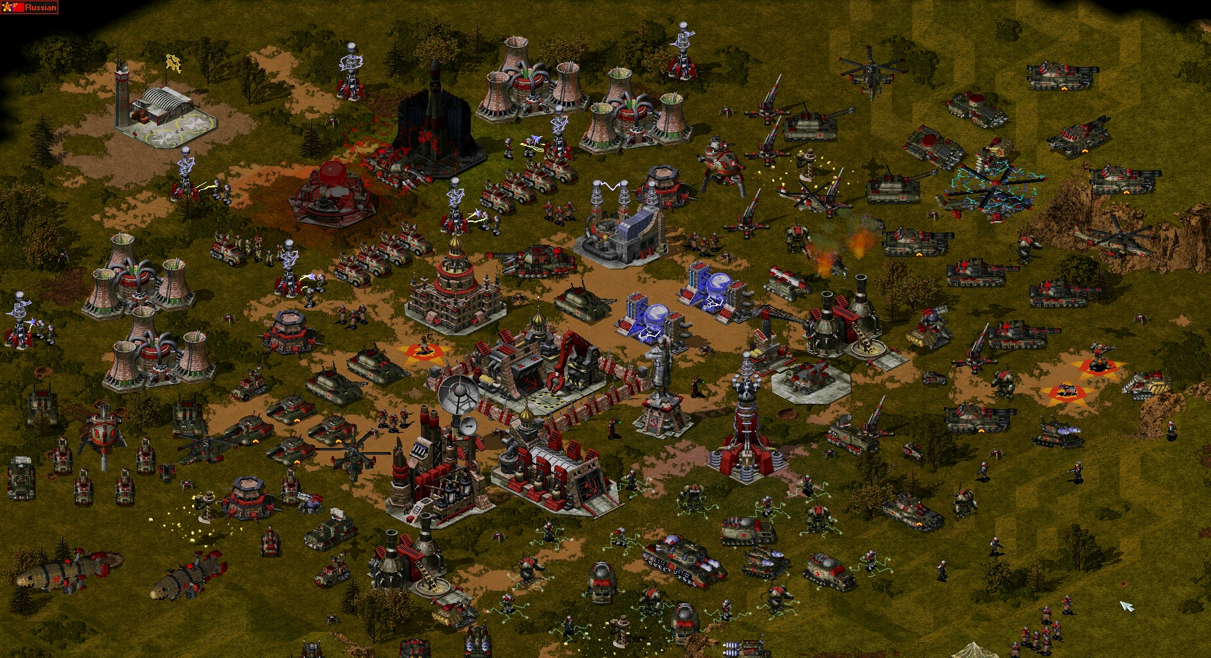 Widok z góry na silnie ufortyfikowaną sowiecką bazę pełną czołgów, helikopterów, żołnierzy i budynków z moda Reboot