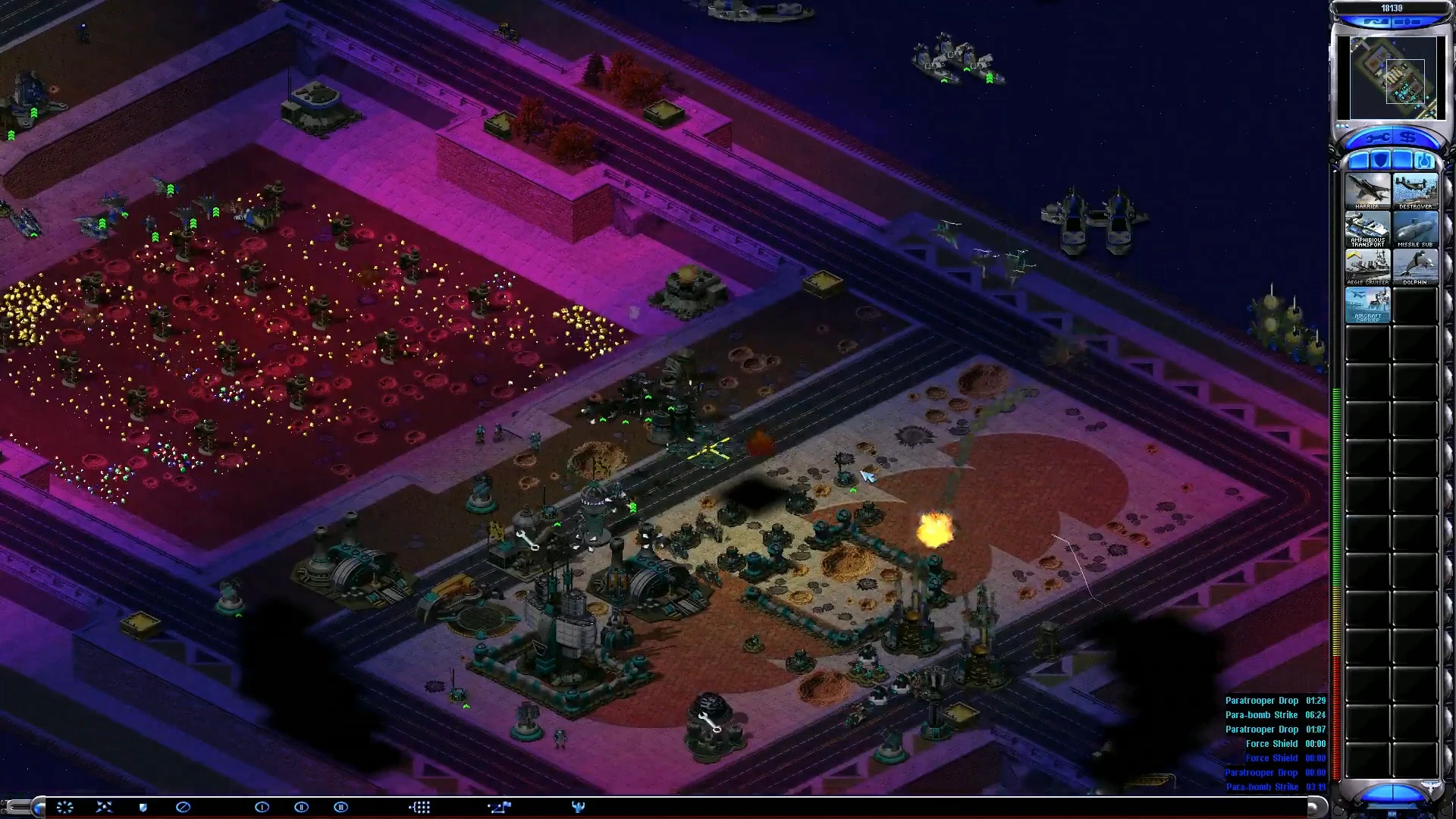 Top-down view of a fortified base under attack with explosions and defensive units in Red Alert 2: Apocalypse mod