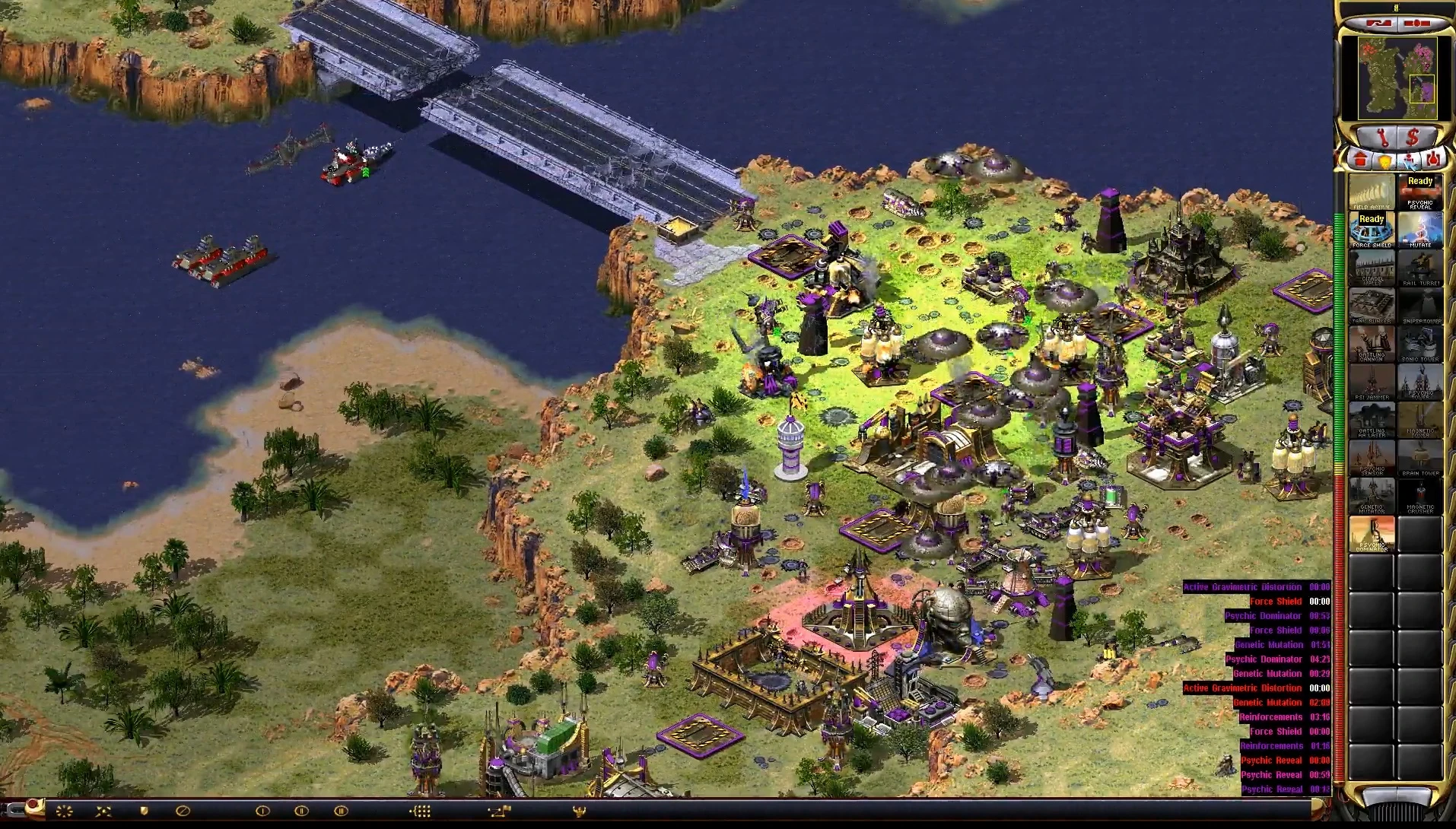 In-game screenshot showing a detailed base with various structures and units near a bridge and water