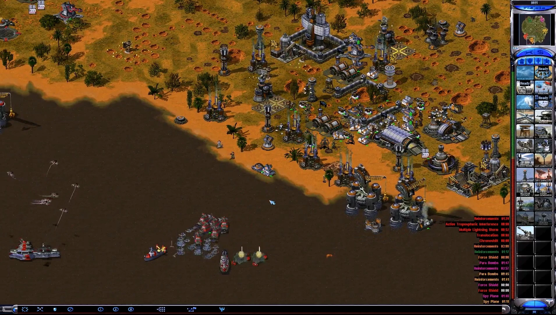 Command & Conquer Yuri's Revenge screenshot showing a base with turrets and naval ships at the shore with game interface