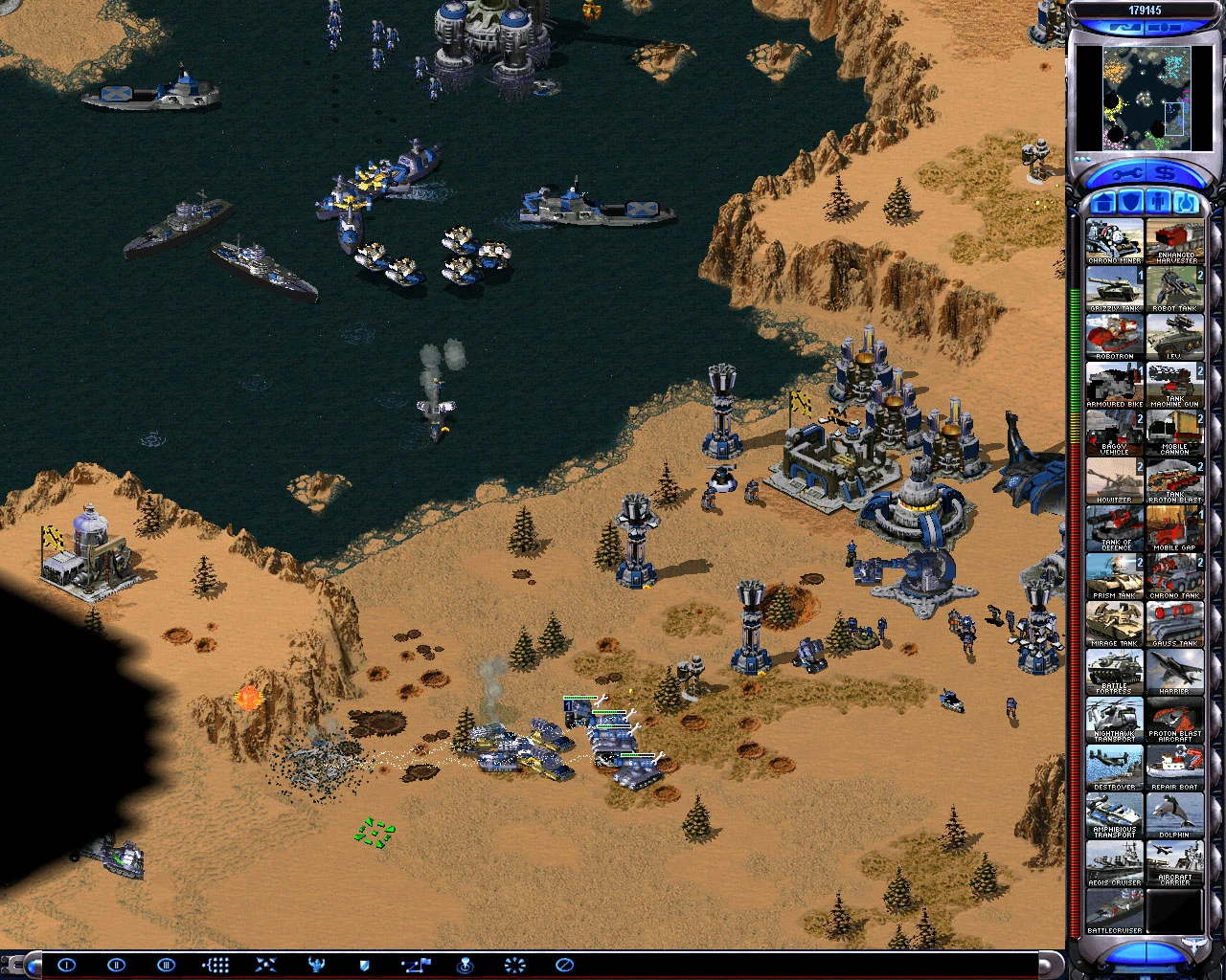 Zrzut ekranu z rozgrywki przedstawiający pustynną bazę nadbrzeżną broniącą się przed okrętami w modzie Begin Disasters do Command & Conquer Yuri's Revenge