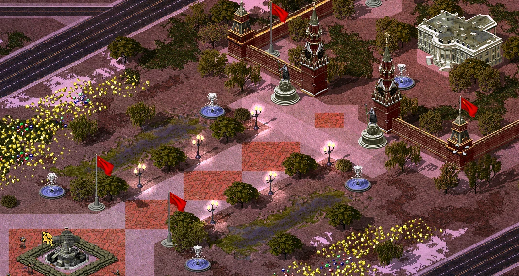 Vista isométrica de una base soviética con banderas rojas, fuentes, farolas y árboles en el mod YR Red-Resurrection de Yuri's Revenge