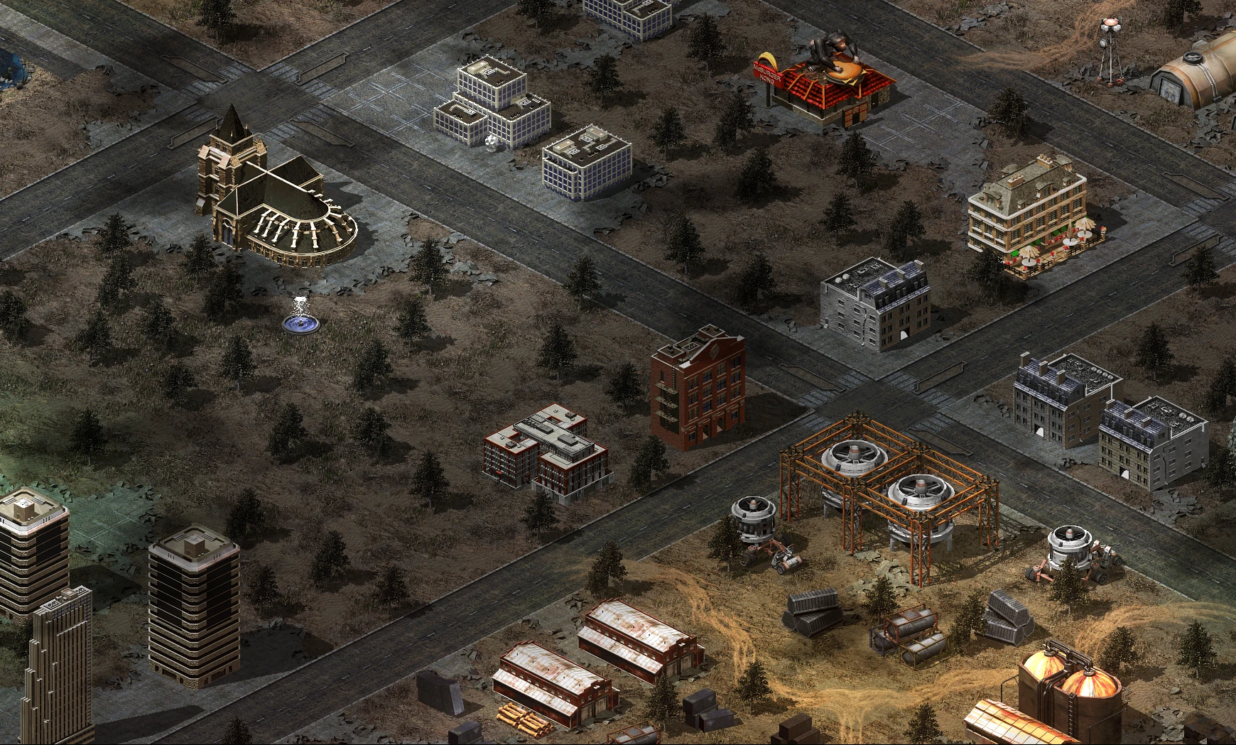 Widok z góry na miejskie i przemysłowe budynki z drogami i drzewami w modzie Tiberium Crisis do Yuri's Revenge