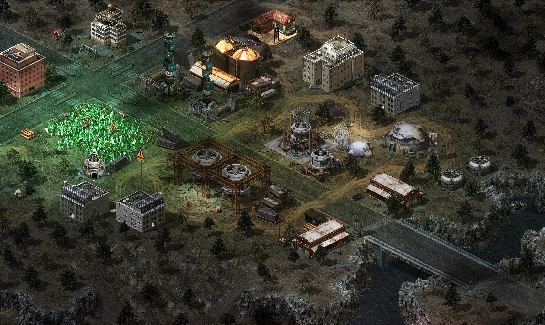 Mod Tiberium Crisis do Command & Conquer Yuri's Revenge z budynkami przemysłowymi, zielonymi kryształami tiberyjskimi i mostem nad wodą