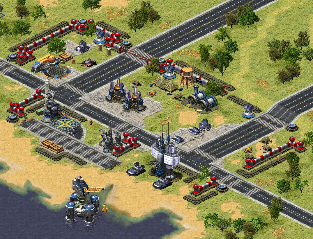 Ufortyfikowana baza wojskowa z murami, wieżyczkami, czołgami i budynkami przy wybrzeżu w modzie Verzov Order do Command & Conquer Yuri's Revenge