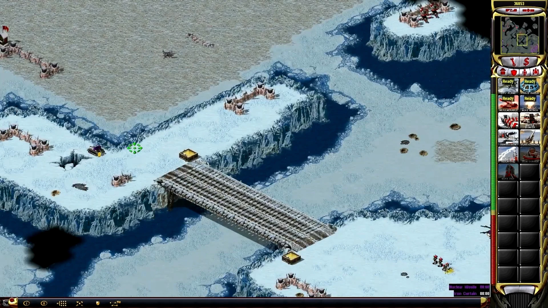 Snow-covered terrain with a large bridge, units, and Command & Conquer Yuri's Revenge HUD visible