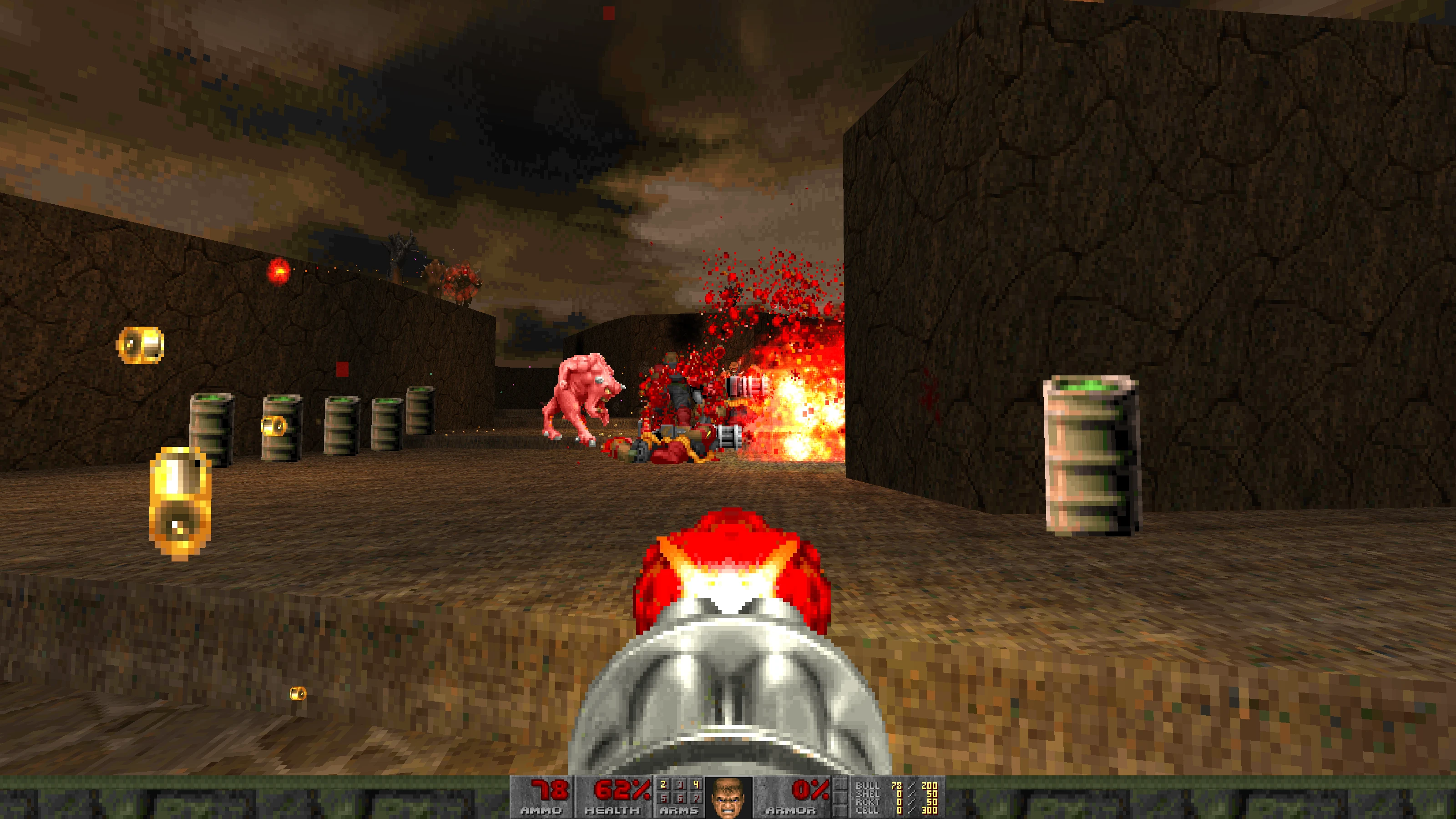 Player shooting at enemies with a chaingun in a rocky outdoor level featuring explosions and flying ammo in Doom II Babel mod