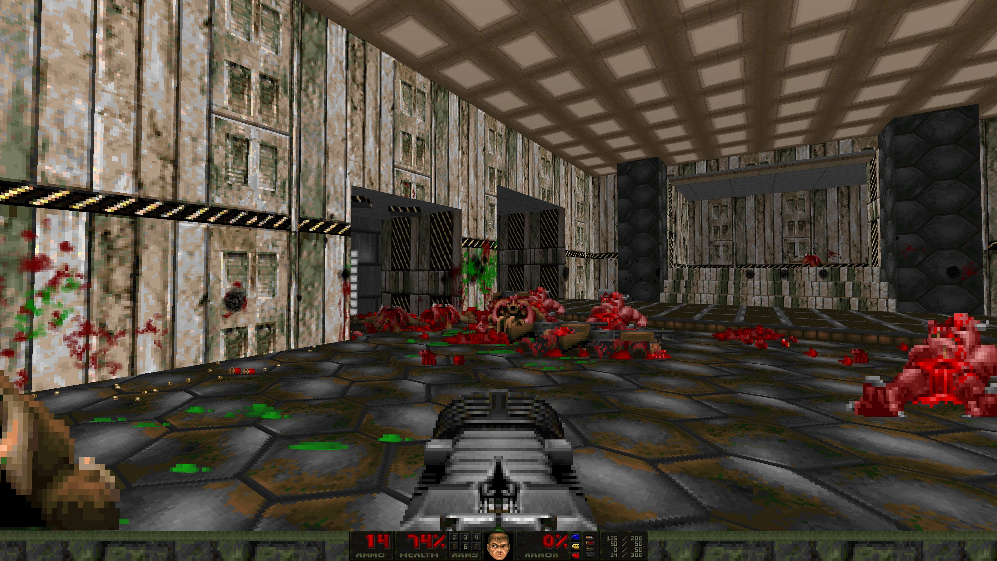 First-person view in Doom II mod Babel showing a player aiming with heavy gun at scattered demon corpses inside industrial room
