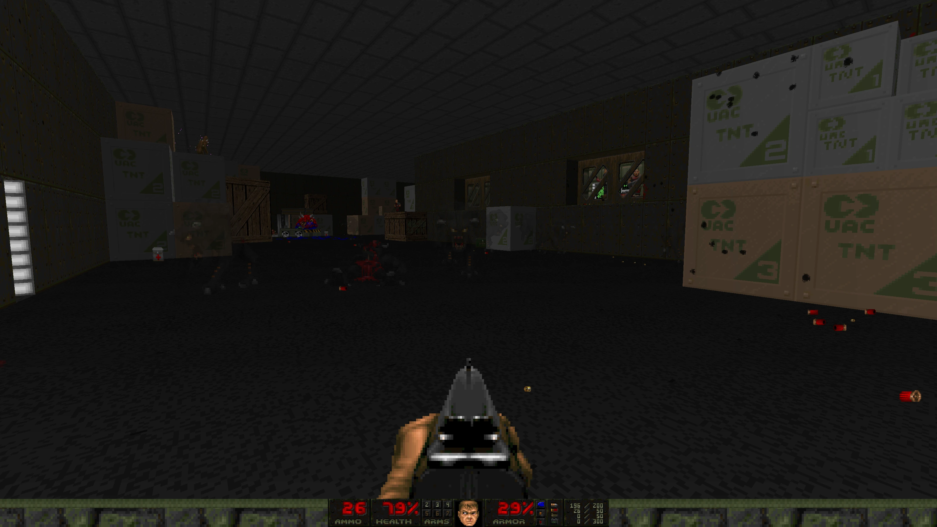 First-person view in Doom II Babel mod showing shotgun aiming inside a warehouse filled with UAC TNT crates and scattered shotgun shells