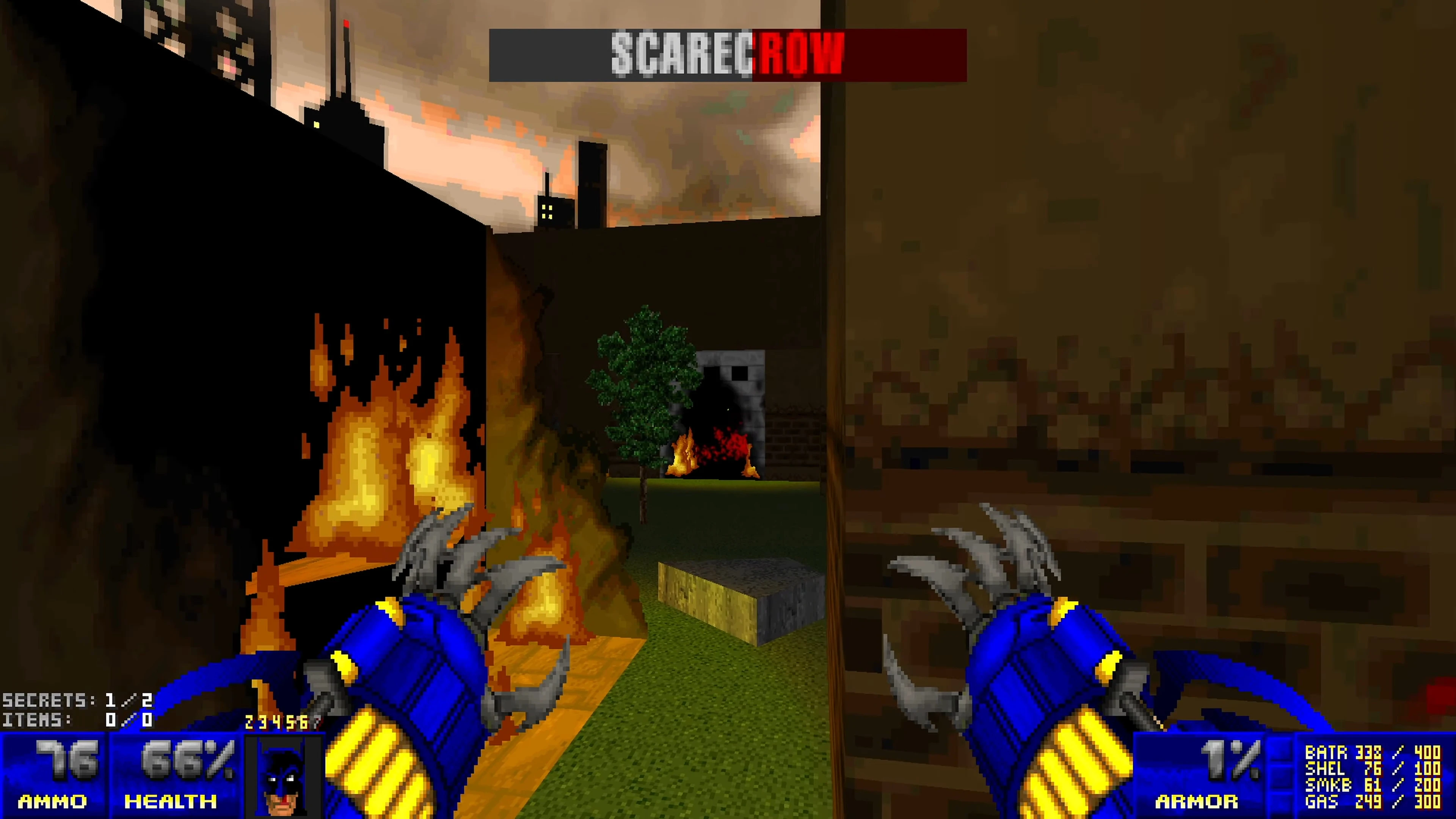 First-person view in Doom II mod showing Batman's clawed gloves near fire and city buildings