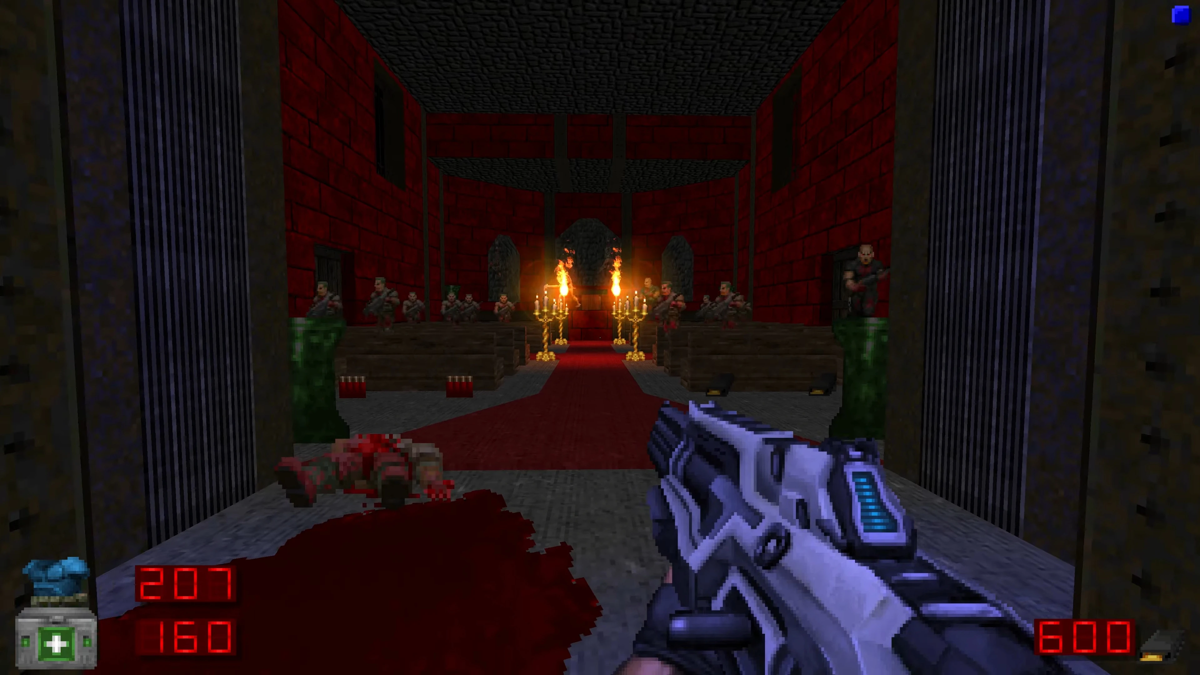 First-person view of a futuristic gun aiming at armored enemies inside a red chapel with candles in Brutal Doom mod