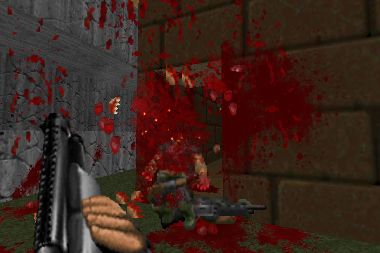 First-person view of a shotgun firing causing heavy blood splatter on a fallen enemy in Doom II Brutal Doom mod