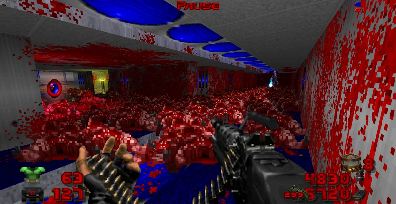 Player wields a large machine gun amid a corridor filled with bloody remains in Brutal Doom mod