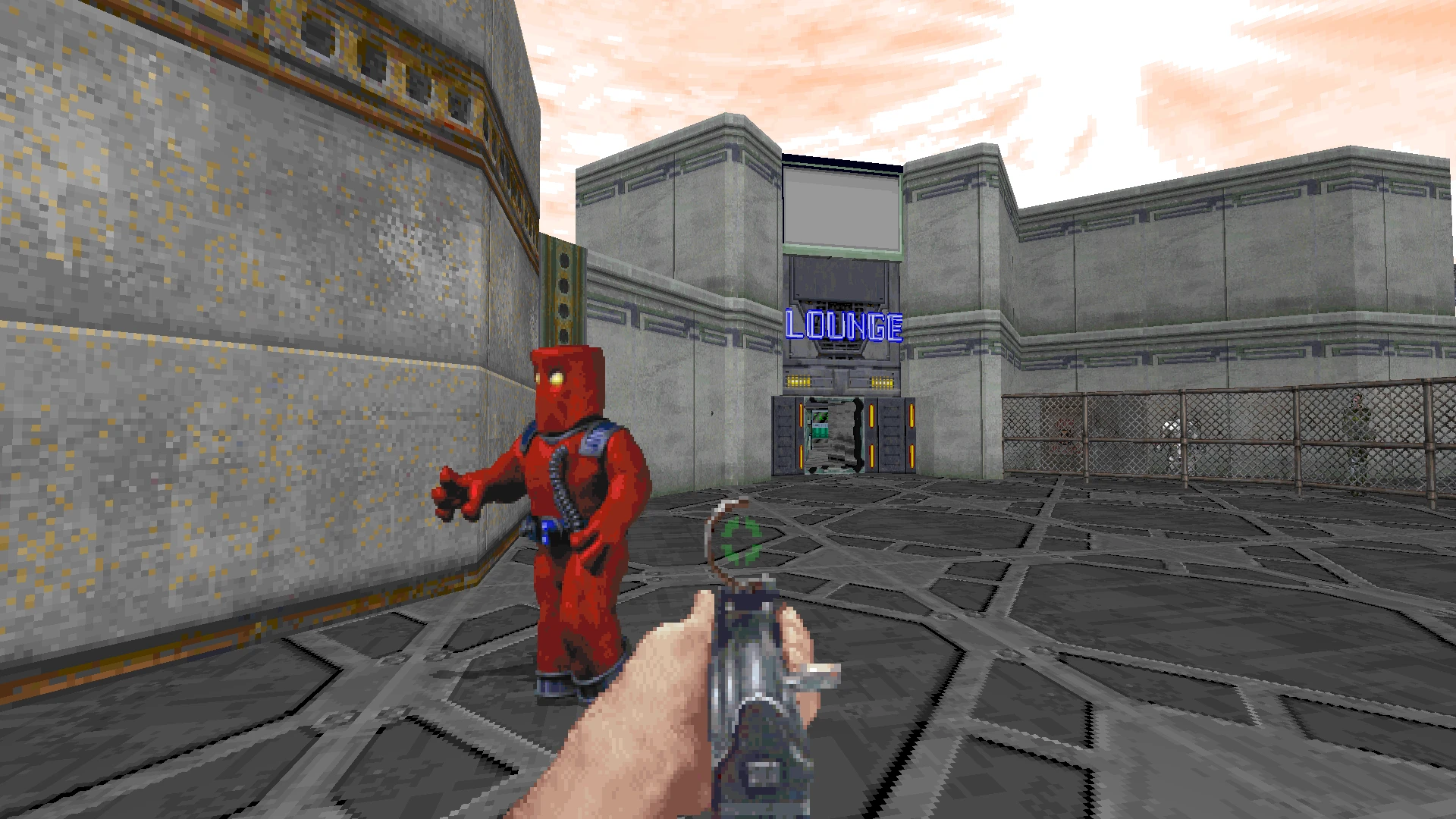 First-person view aiming at a red-suited character on a metal floor near a building labeled LOUNGE