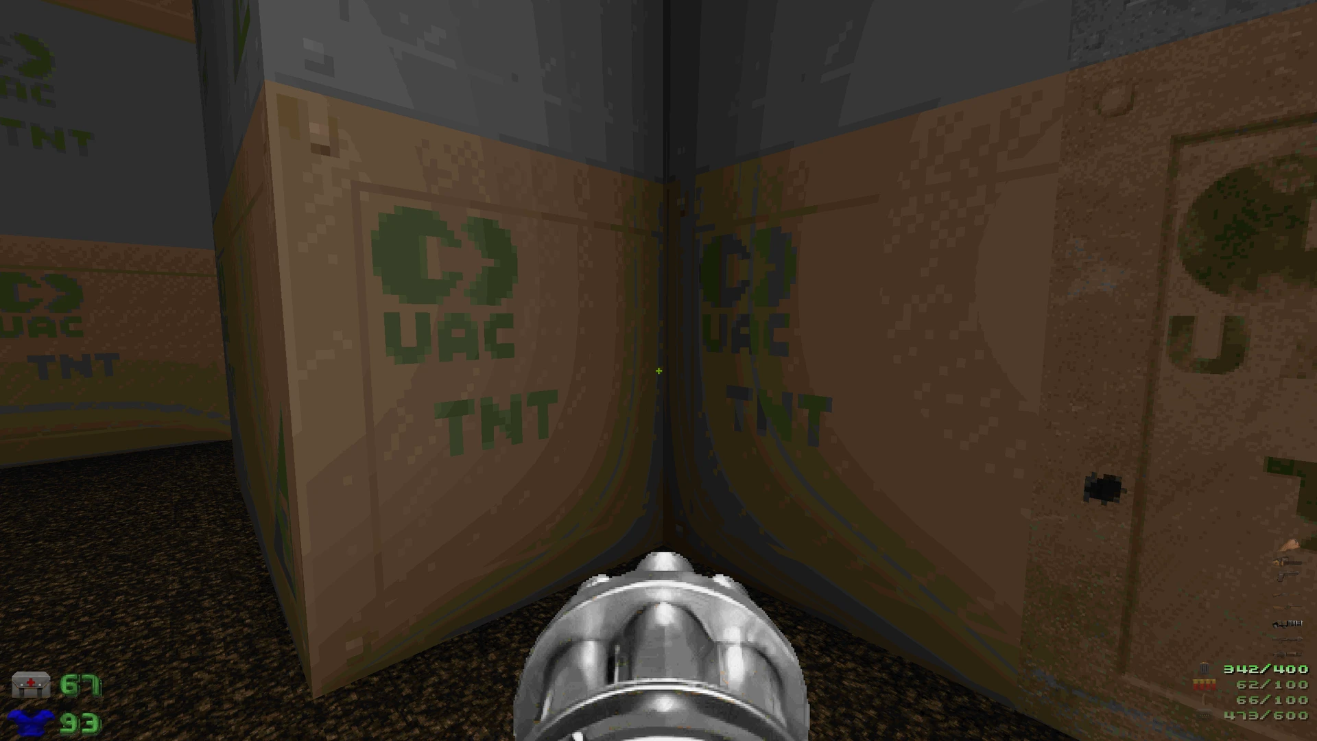 Вид від першої особи в Doom II з бочками з написом UAC TNT та мініганом у руках