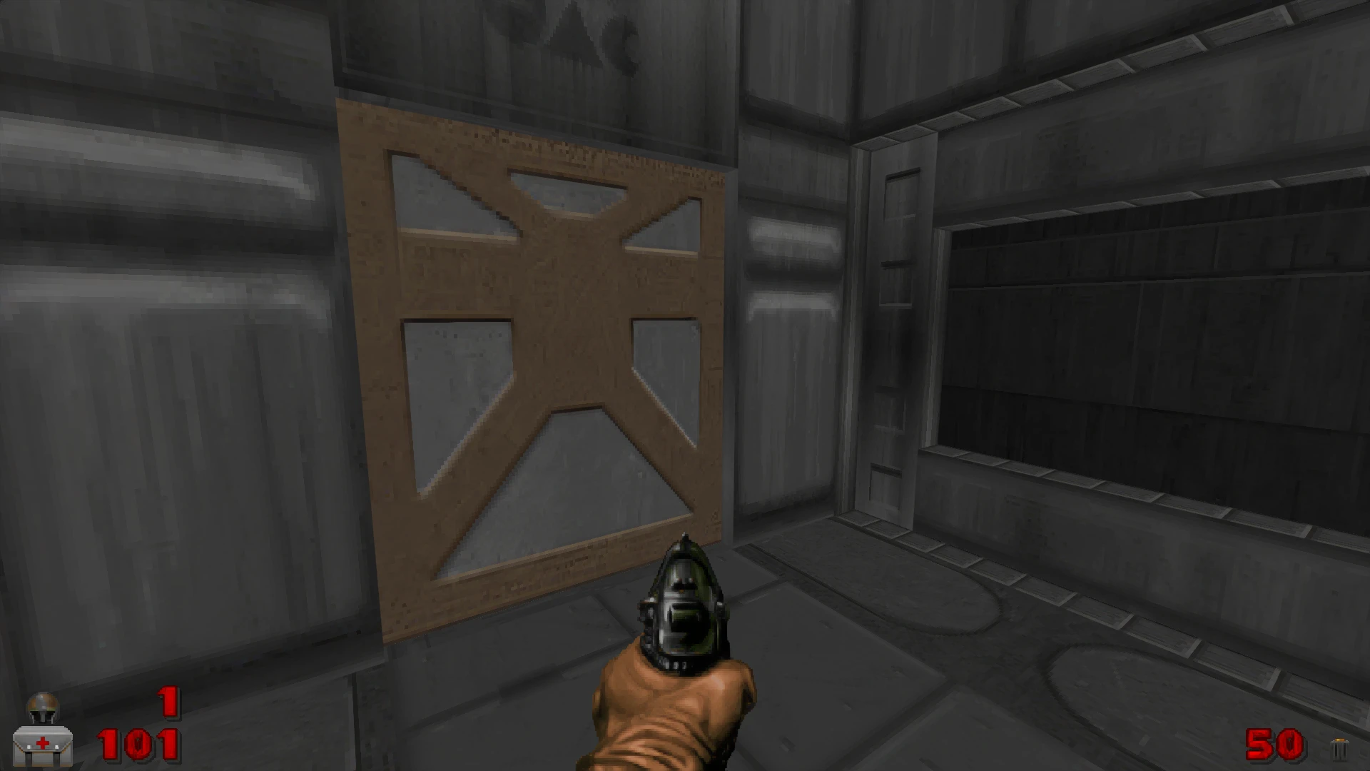 Скріншот гри Doom II з пістолетом, спрямованим на закриті механічні двері, індикатори здоров’я та боєприпасів