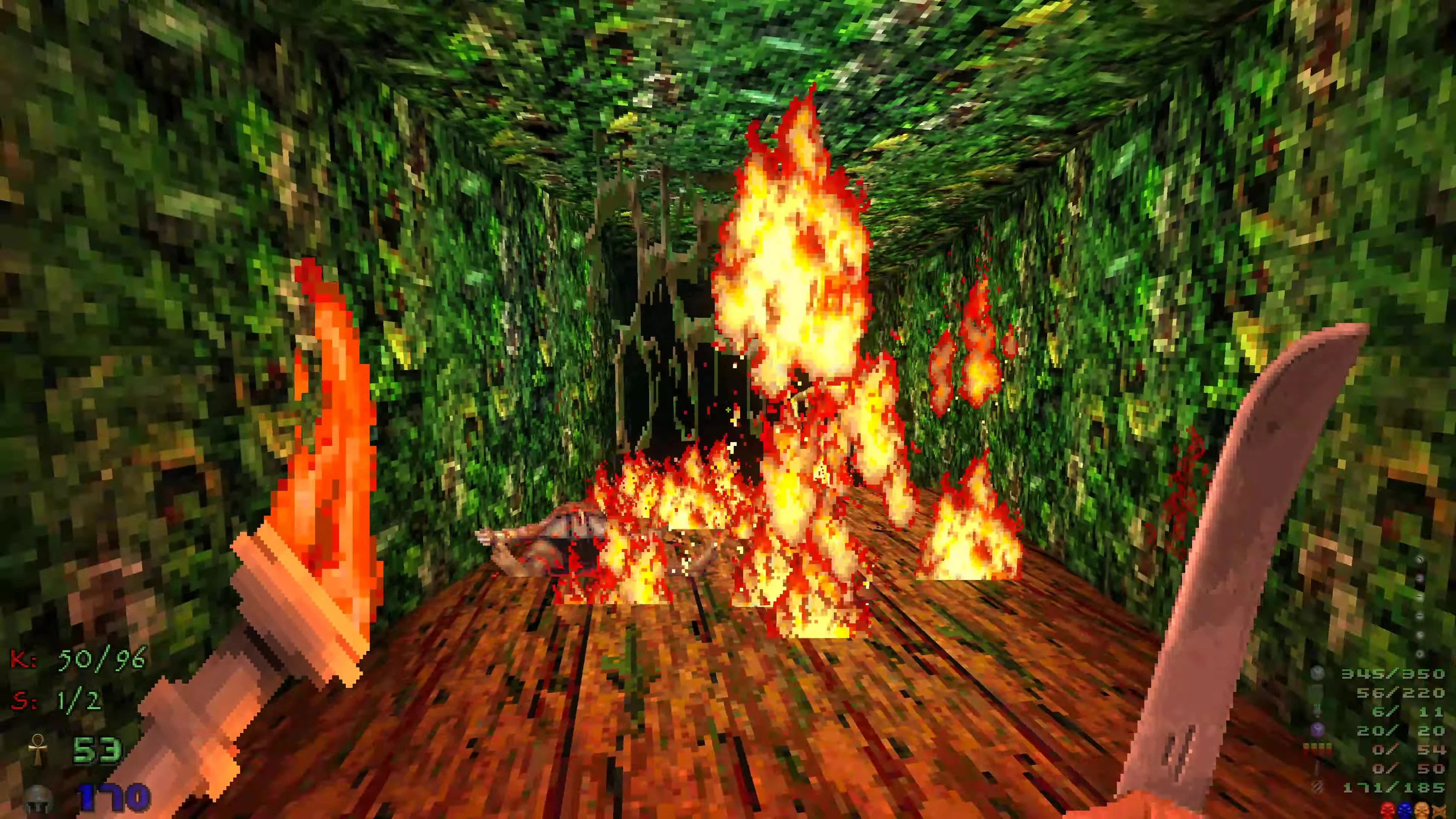 First-person view of flaming battle in a leafy jungle corridor with a machete sword from DoomExhumed mod