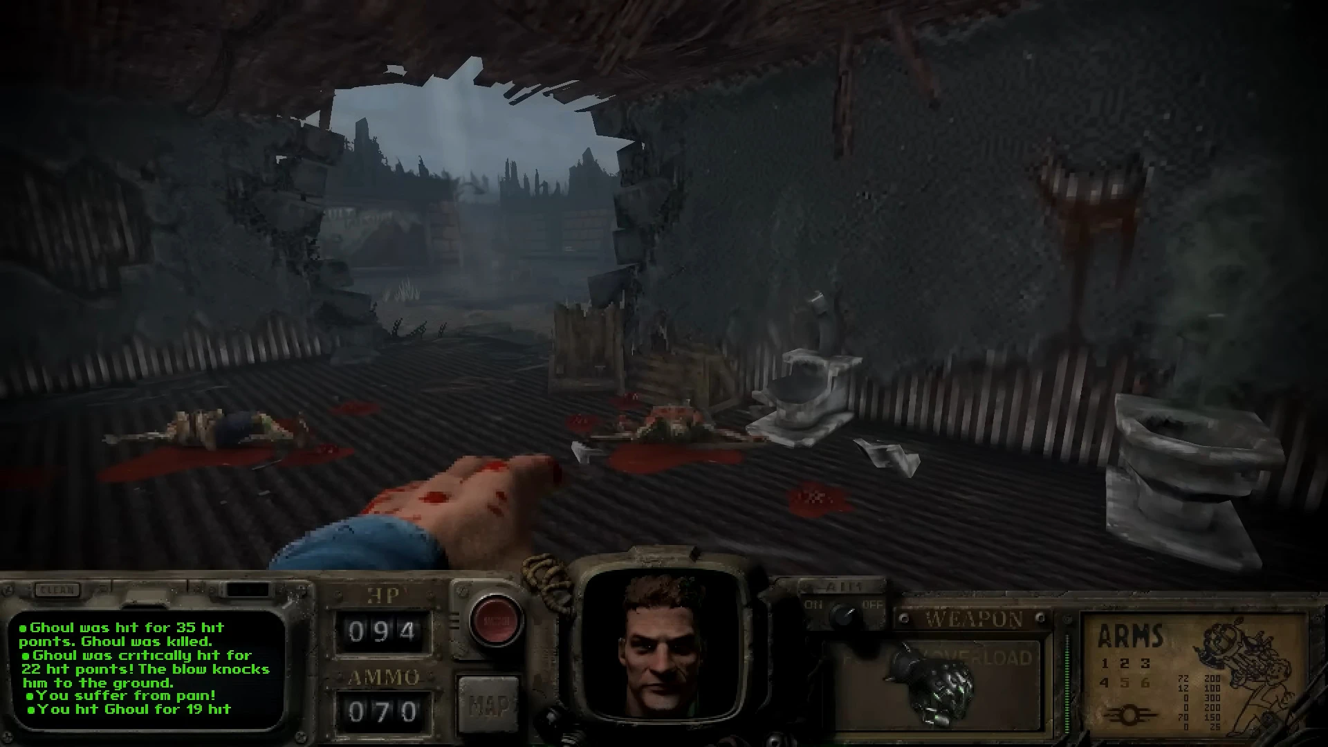 First-person view showing a damaged building interior with dead bodies and a bloodied hand in Fallout Bakersfield mod for Doom II