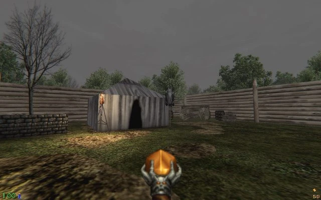 First-person view of Doom II IronTusks mod with medieval tent, wooden walls, and barren trees