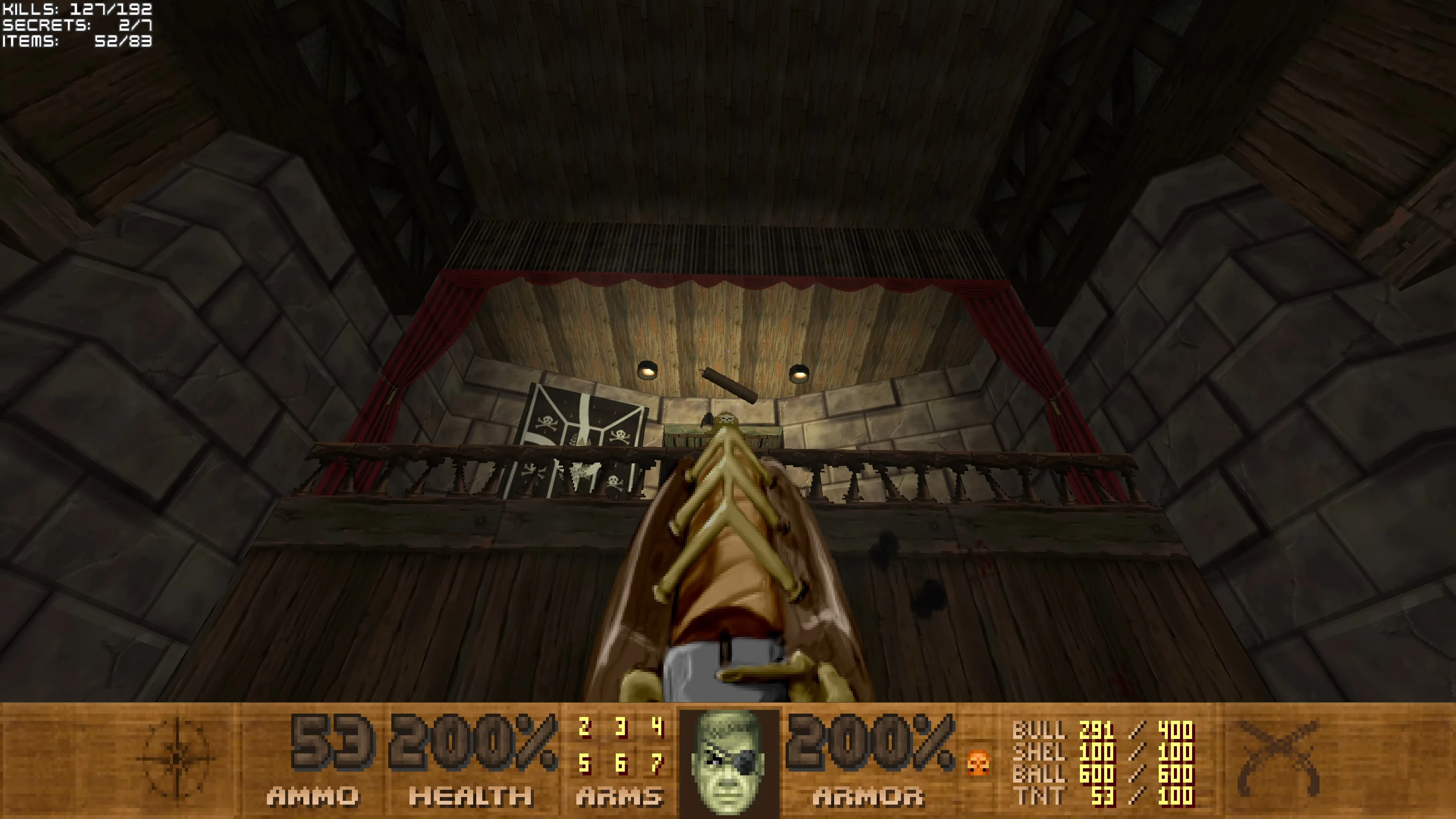 First-person view aiming at wooden ship interior with pirate flag and HUD ammo, health and armor