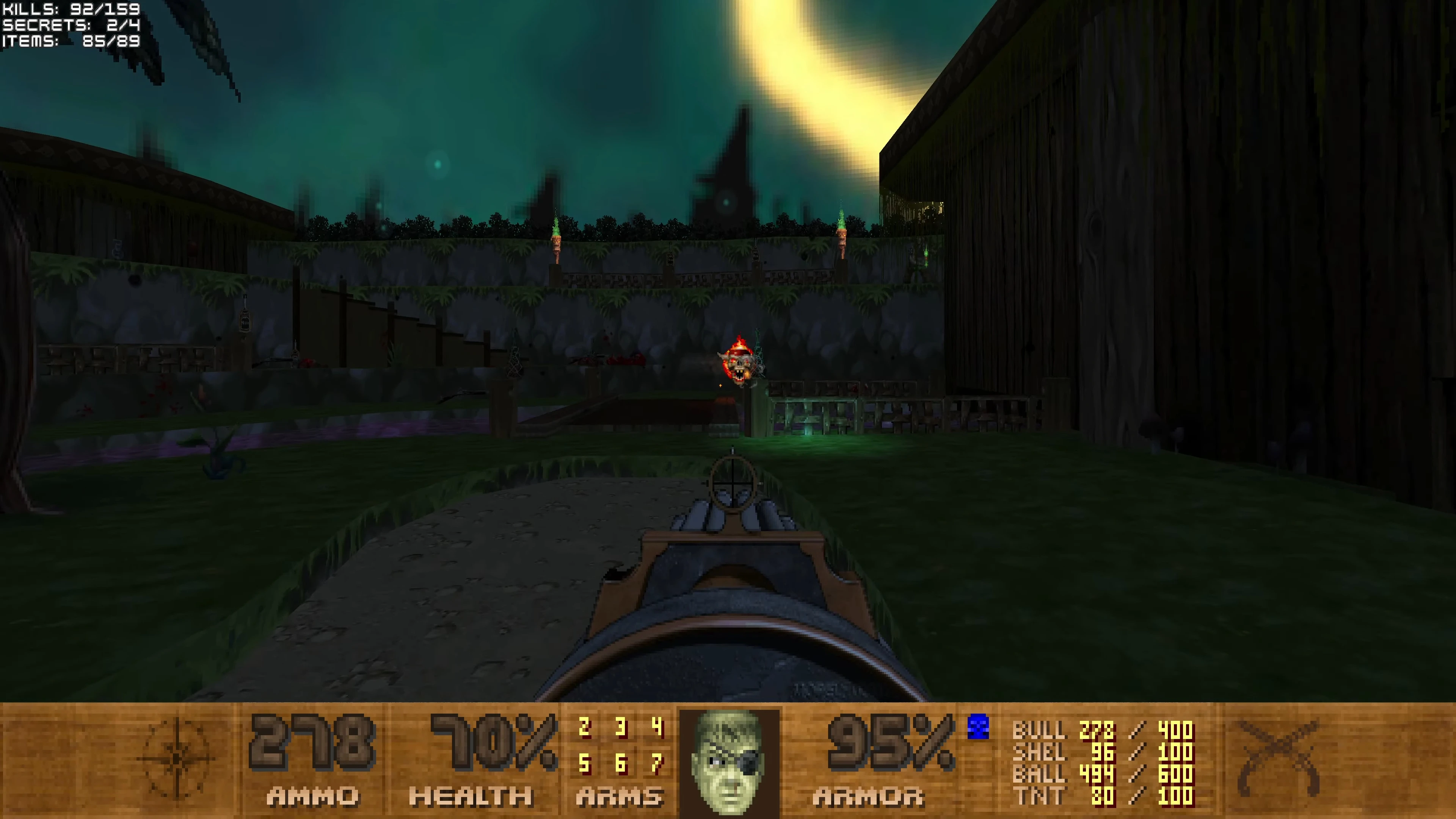 First-person view in Doom II Pirate Doom mod showing aiming at a fiery skull enemy in a fenced outdoor area