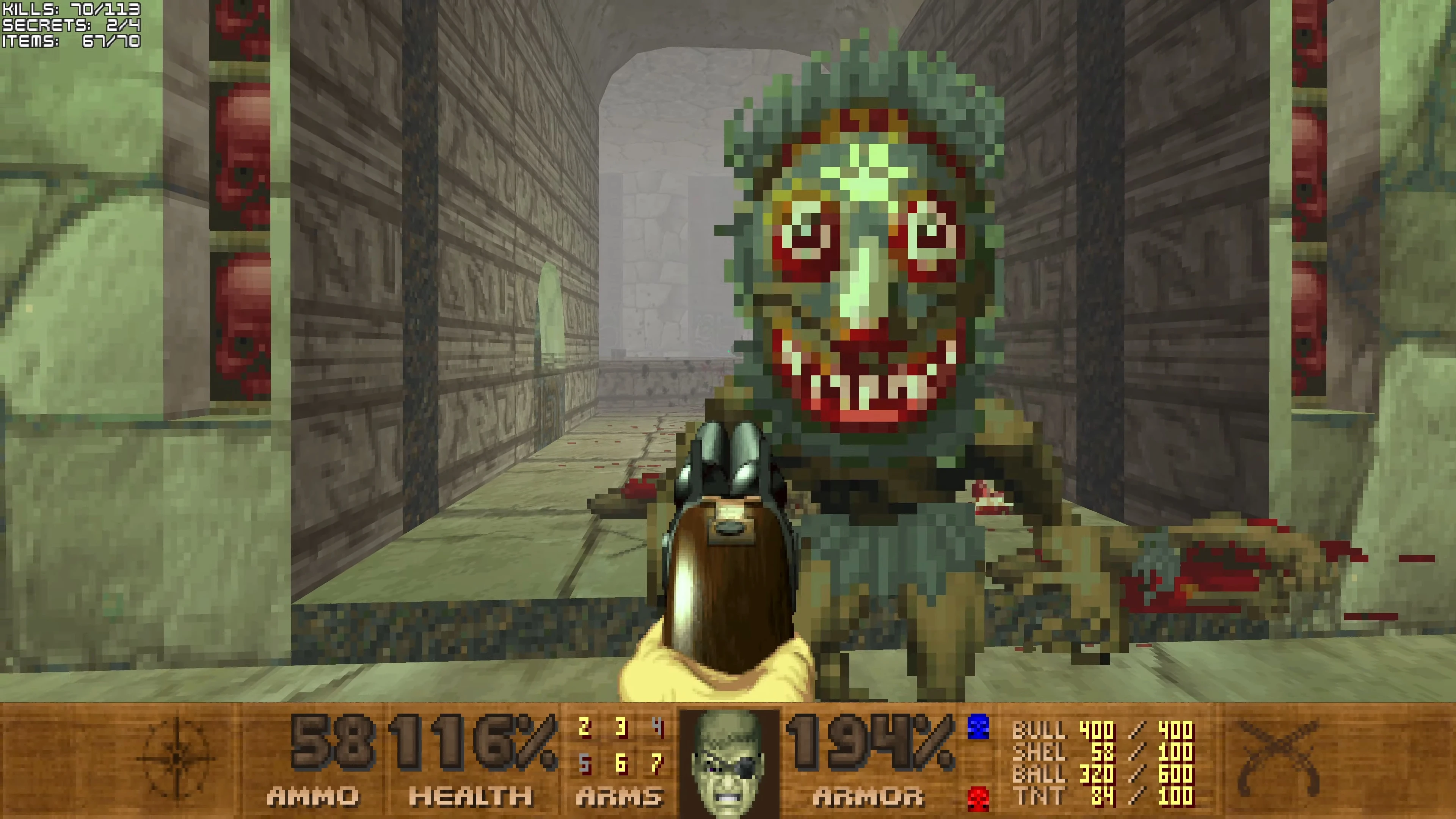 Player aiming shotgun at a large pixelated grotesque enemy with red eyes inside a stone corridor from Doom II Pirate Doom mod