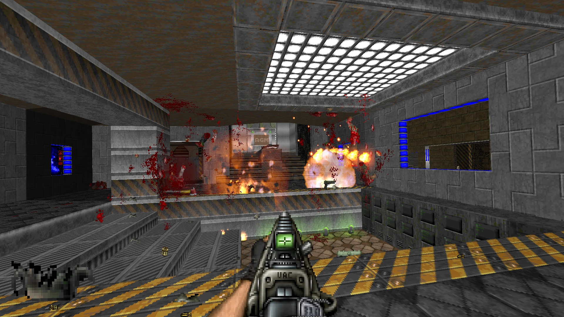 First-person view of shooting with explosions and blood splatter in industrial setting in Doom II Project Brutality mod
