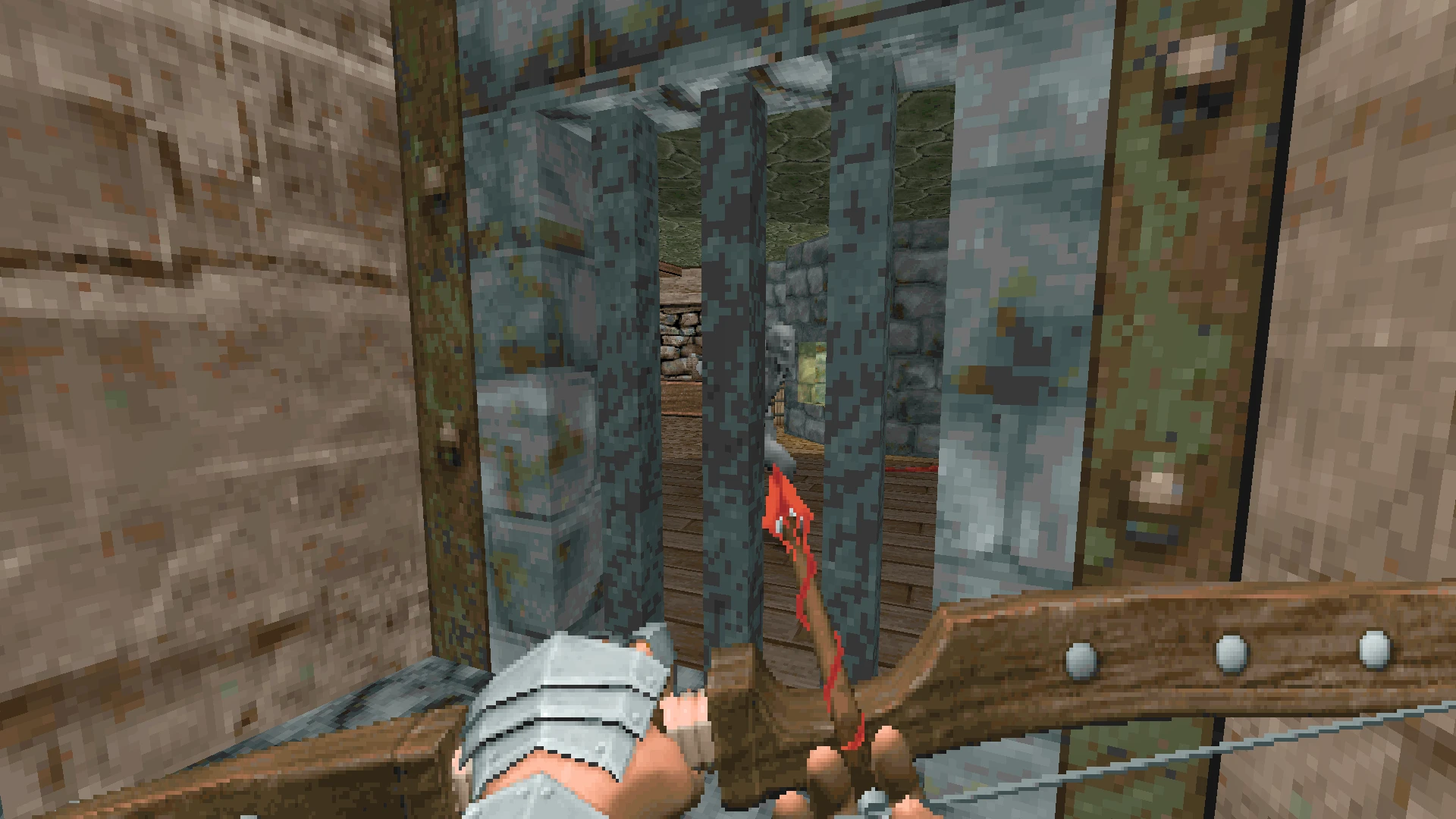 Player holding a crossbow aiming through metal prison bars at a stone-walled room in Doom 1993 REKKR mod