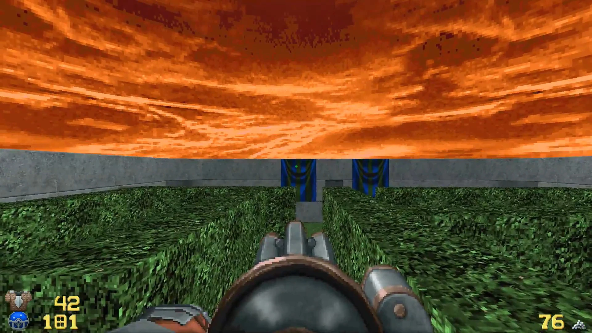 First-person view in Doom 1993 REKKR mod of player aiming shotgun in a green hedge maze under an orange sky